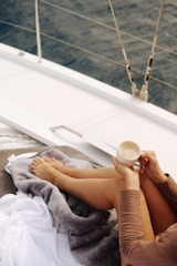 Relaxing on a boat with coffee and ocean view.