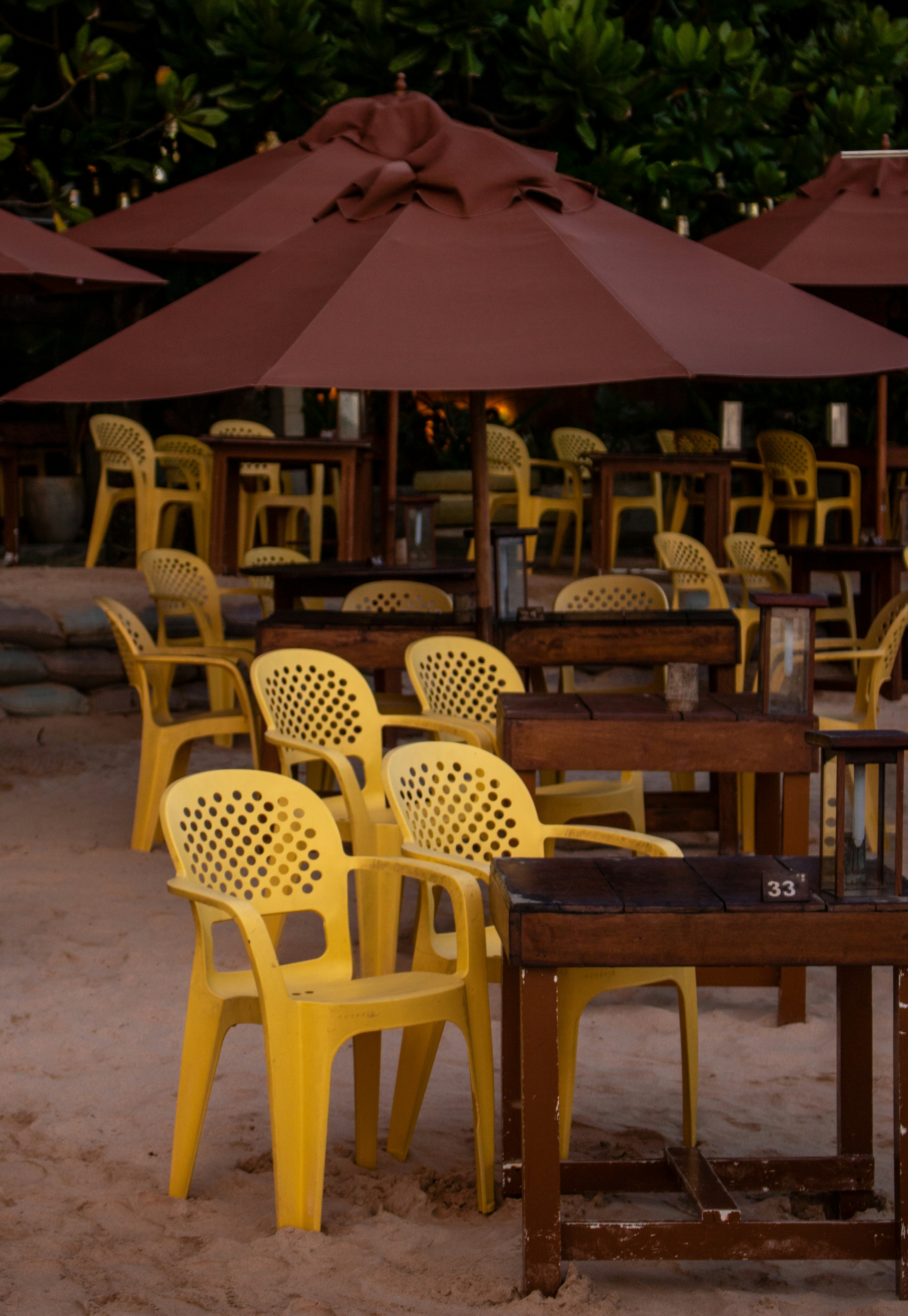 Empty restaurant seating under umbrellas.