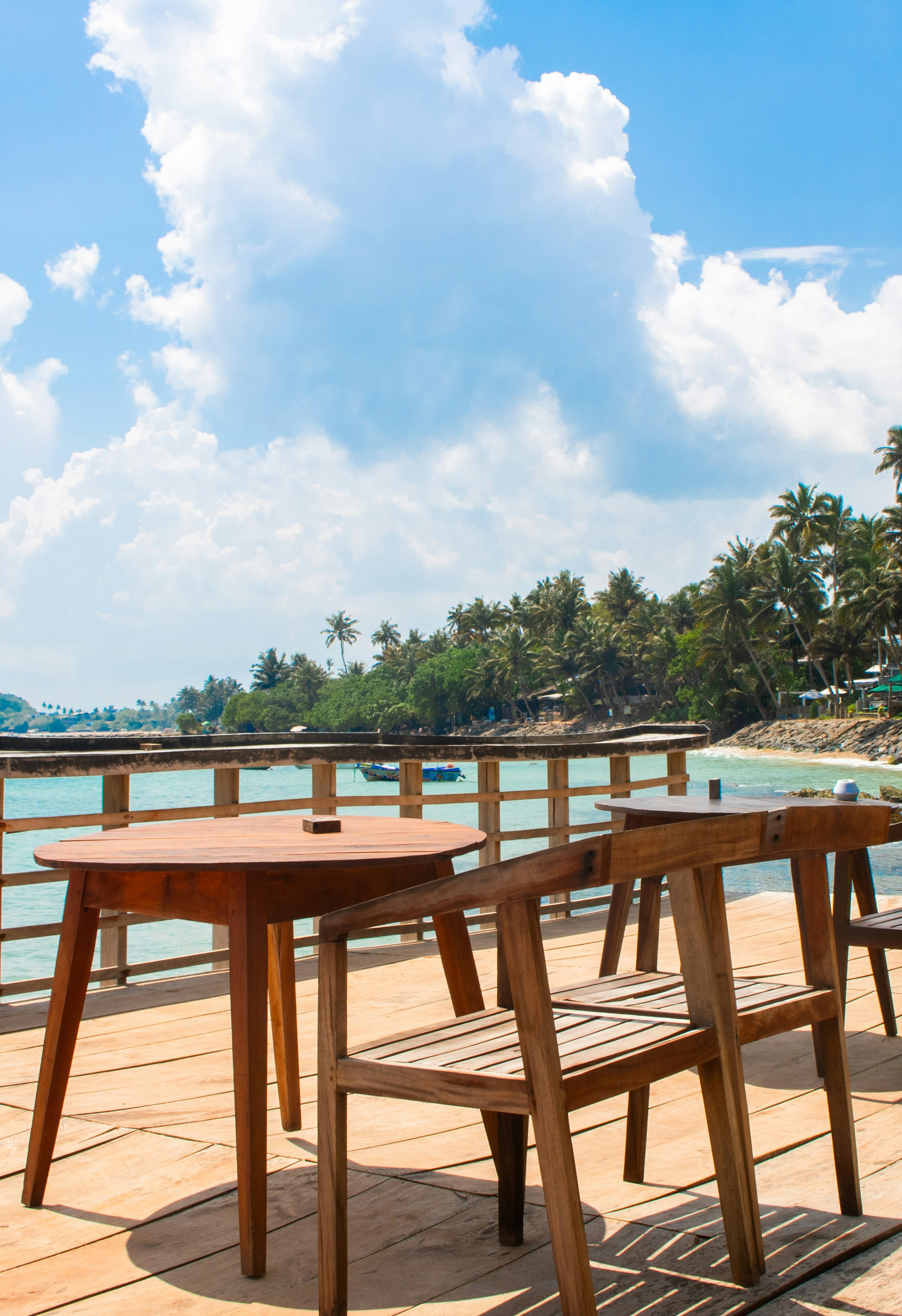Outdoor dining setup with a view of the sea and sky.