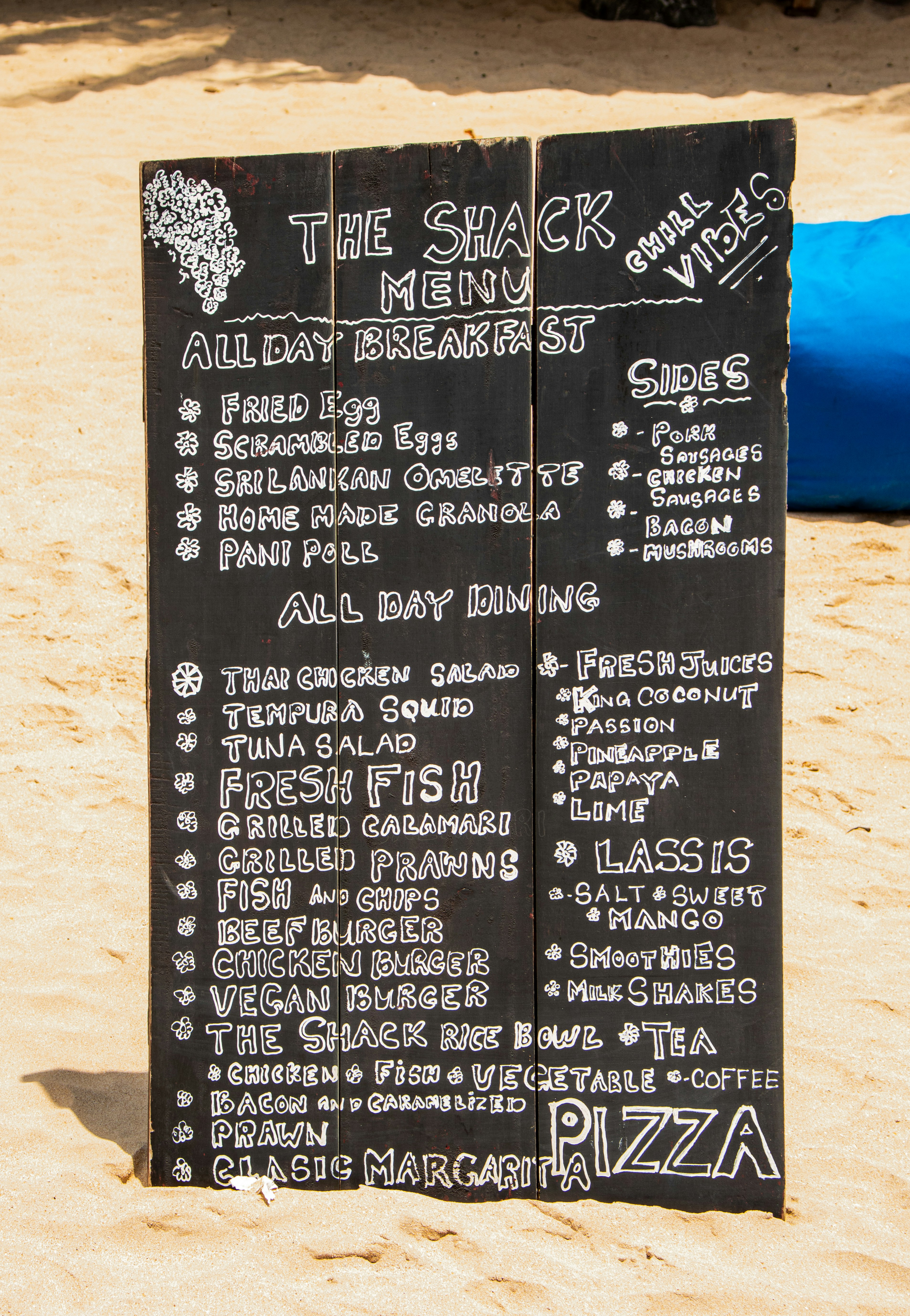 The shack's menu is displayed on a handwritten sign.