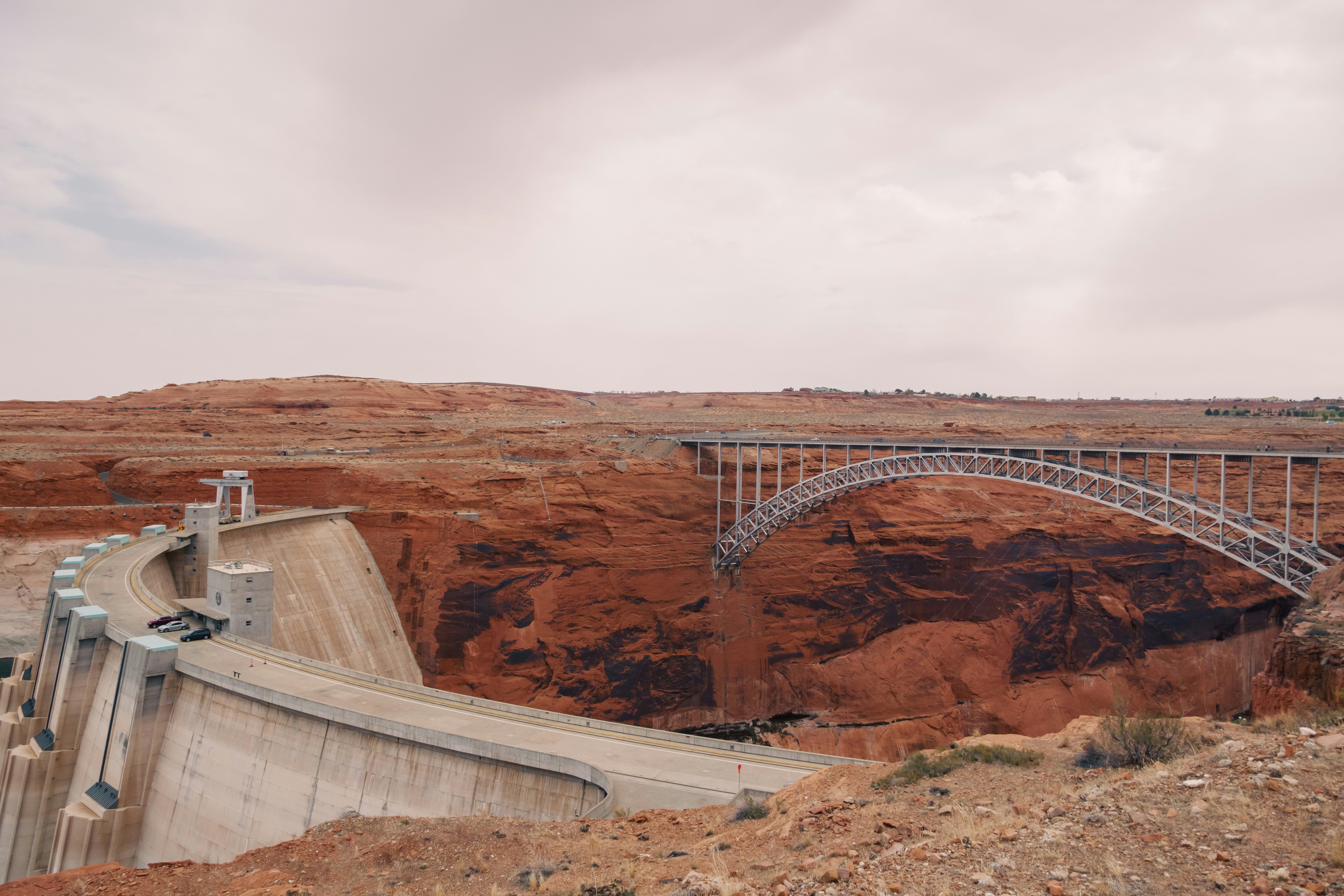 A dam and bridge span a canyon.
