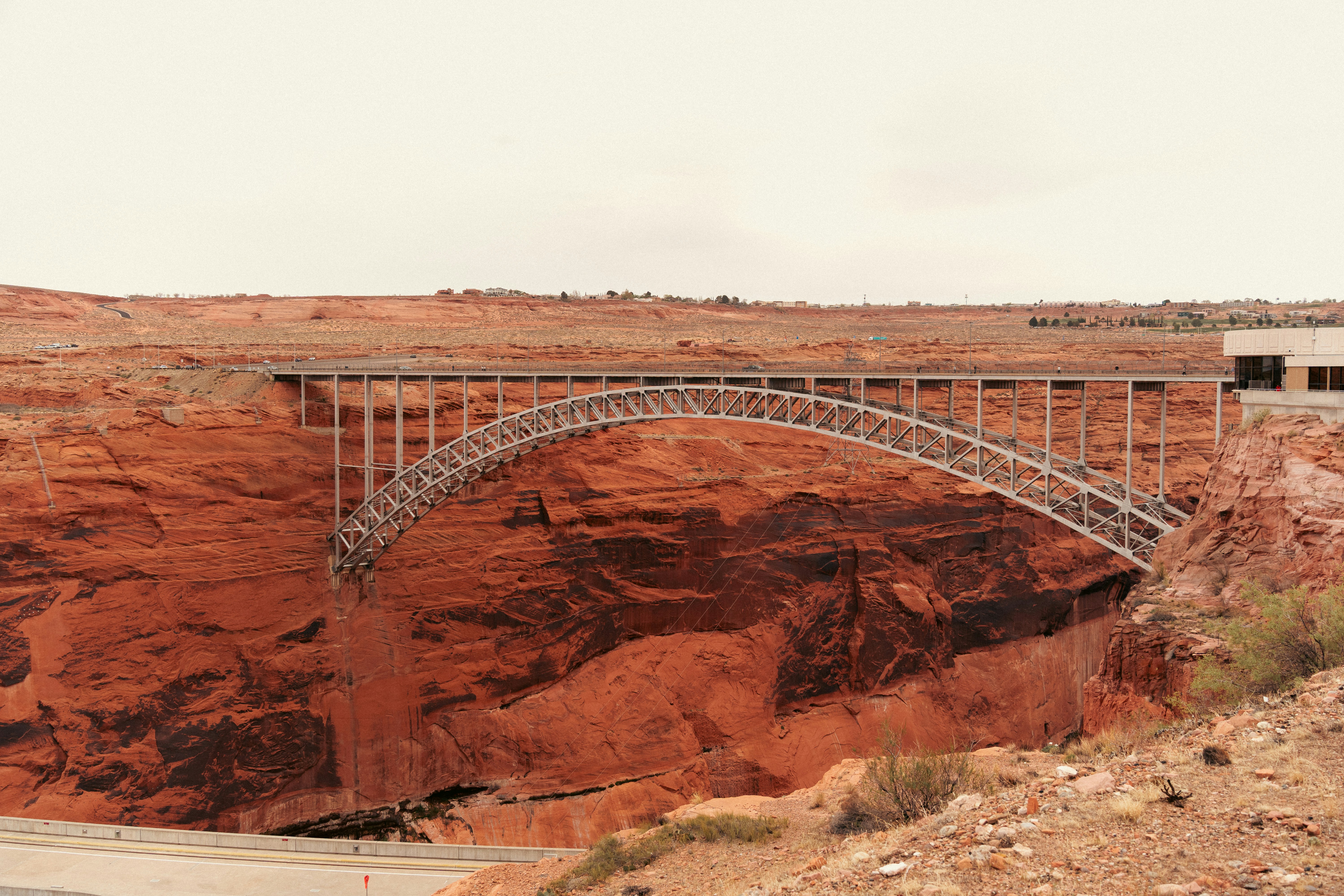 A bridge spans a red rock canyon.