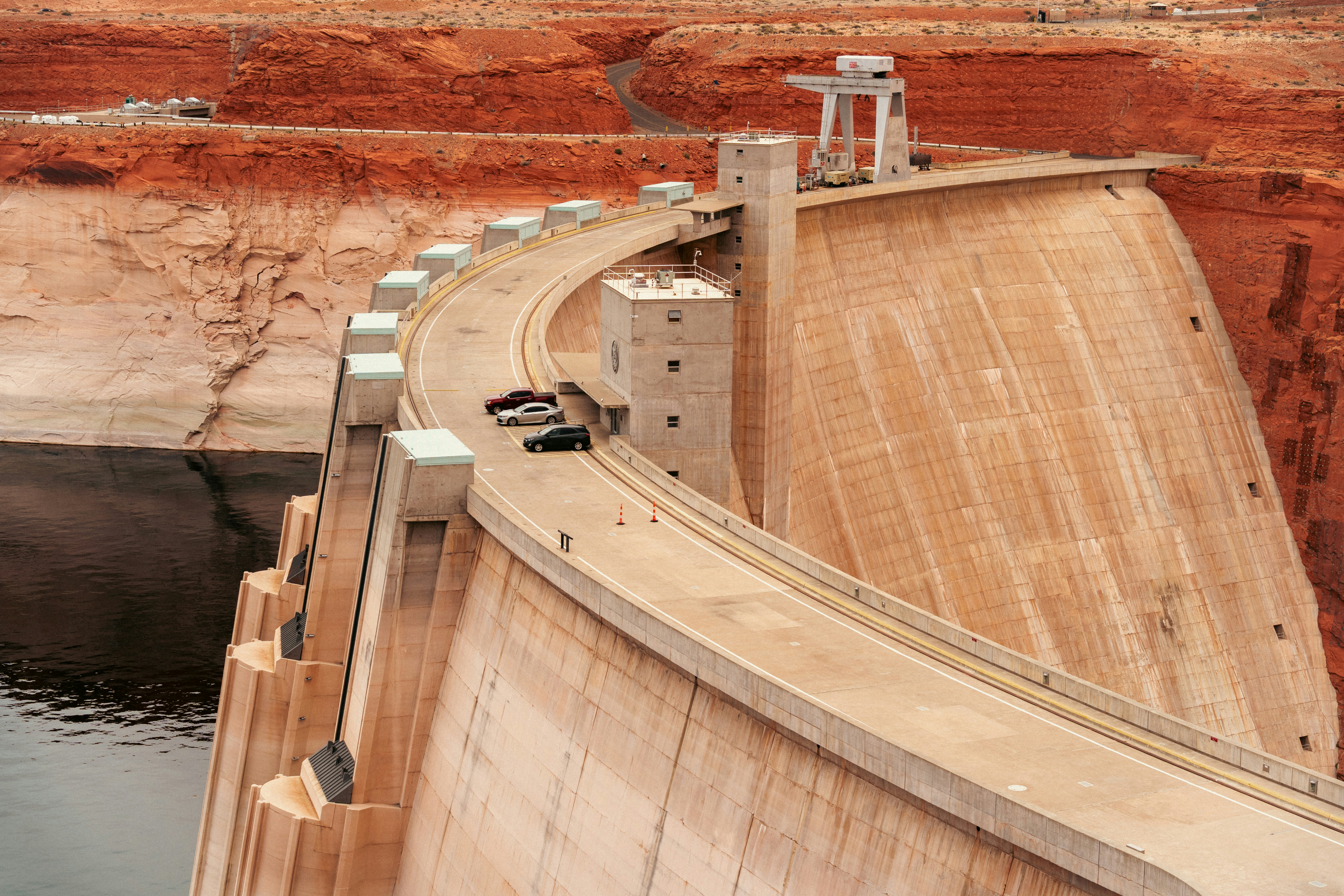 A tall dam stands against the landscape.