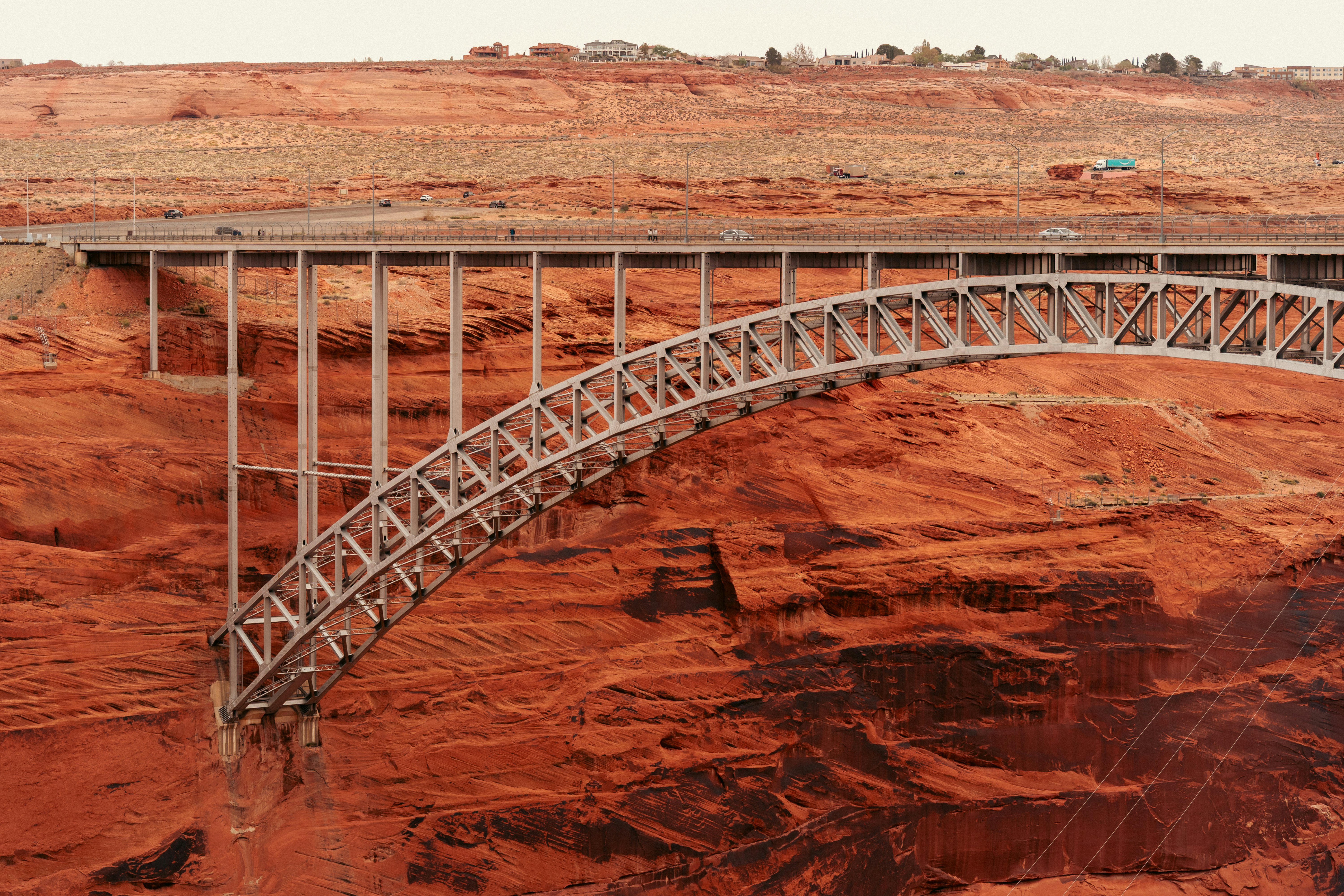 A bridge spans across a red rock canyon.