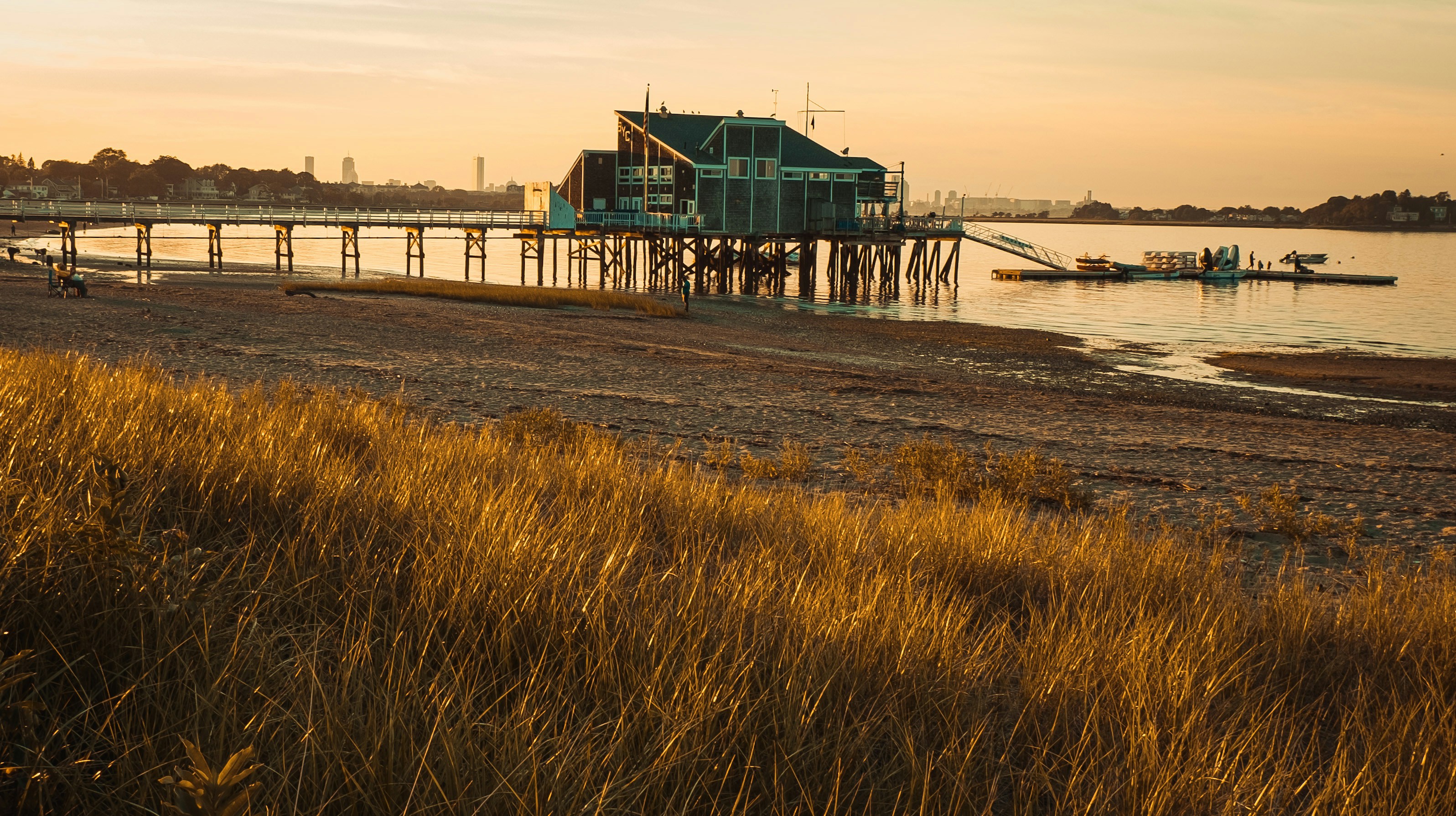 A building stands on a pier at sunset