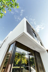 Modern white building against a beautiful, blue sky.