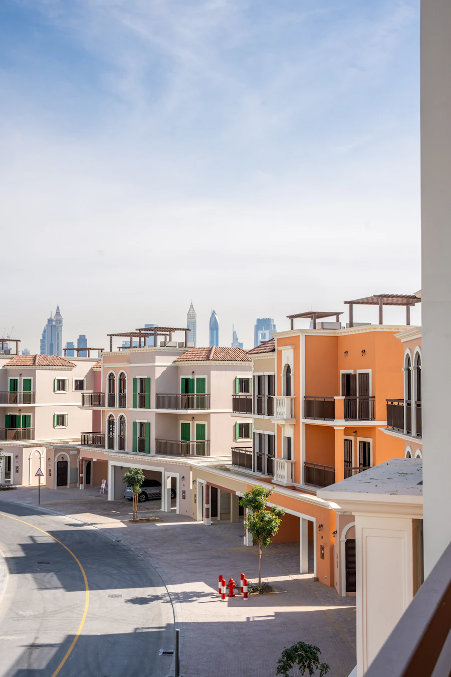 Mediterranean-style townhouses with the Dubai skyline behind