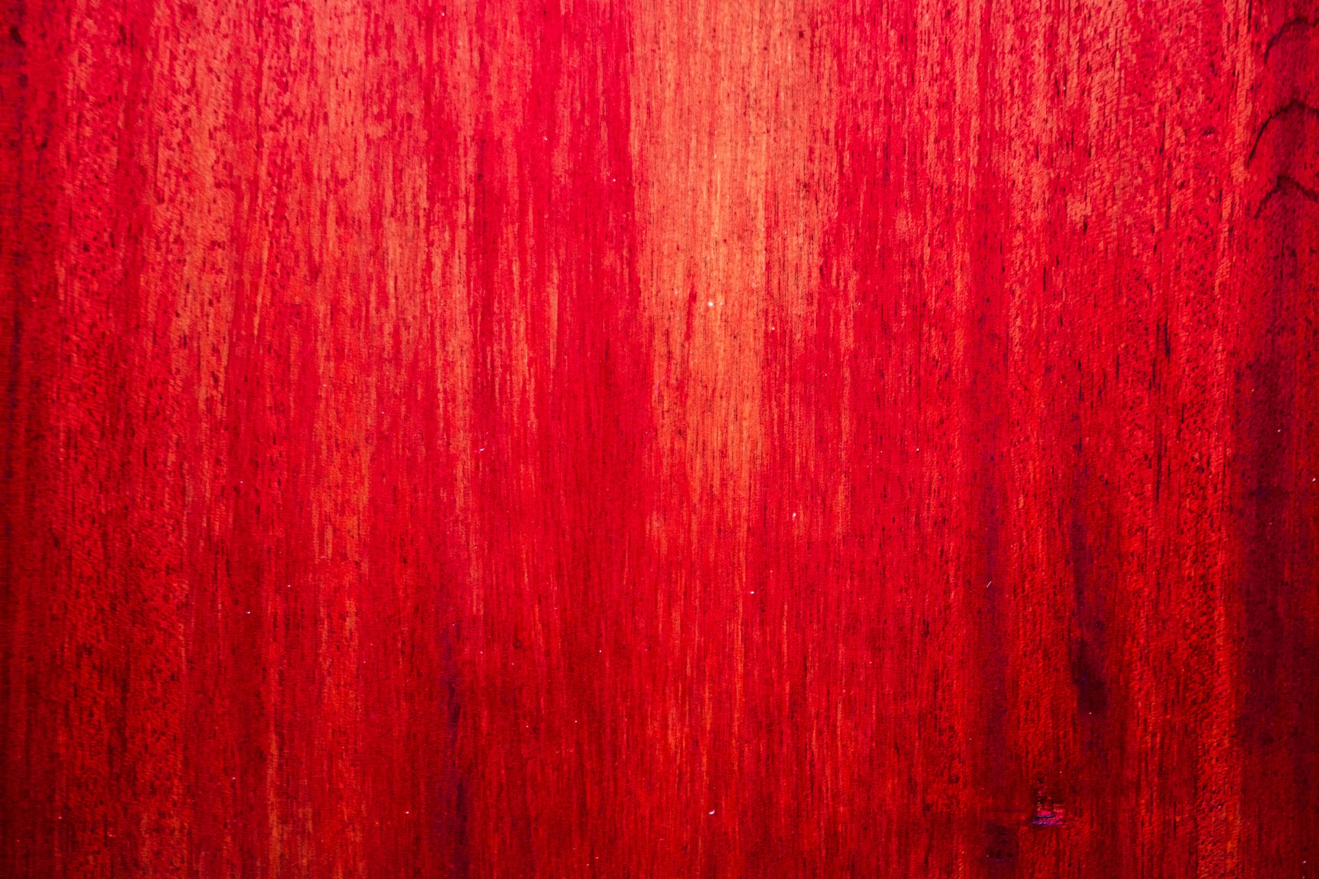 Red wood grain fills the entire frame.
