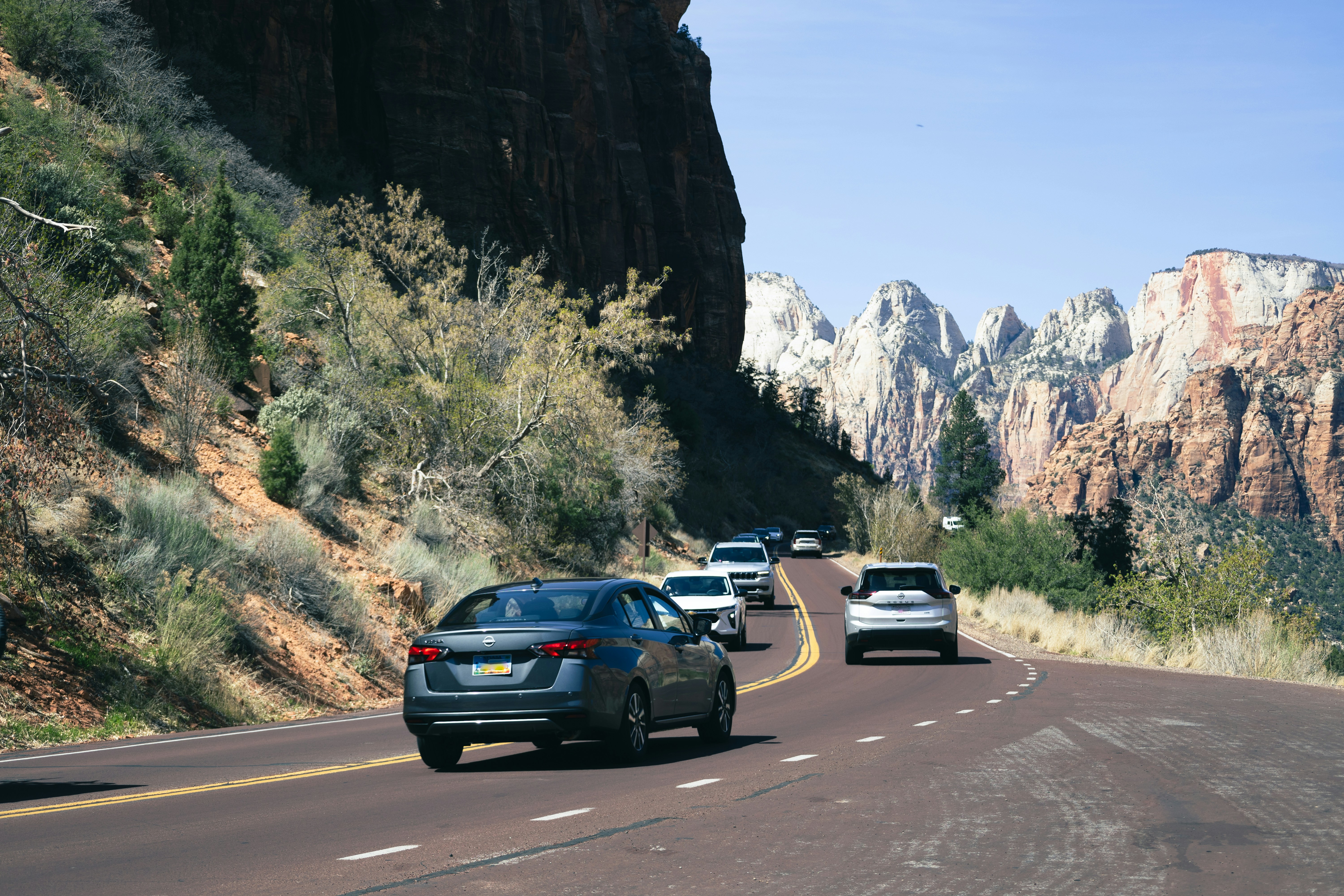 Family loading luggage into an electric SUV before a road trip