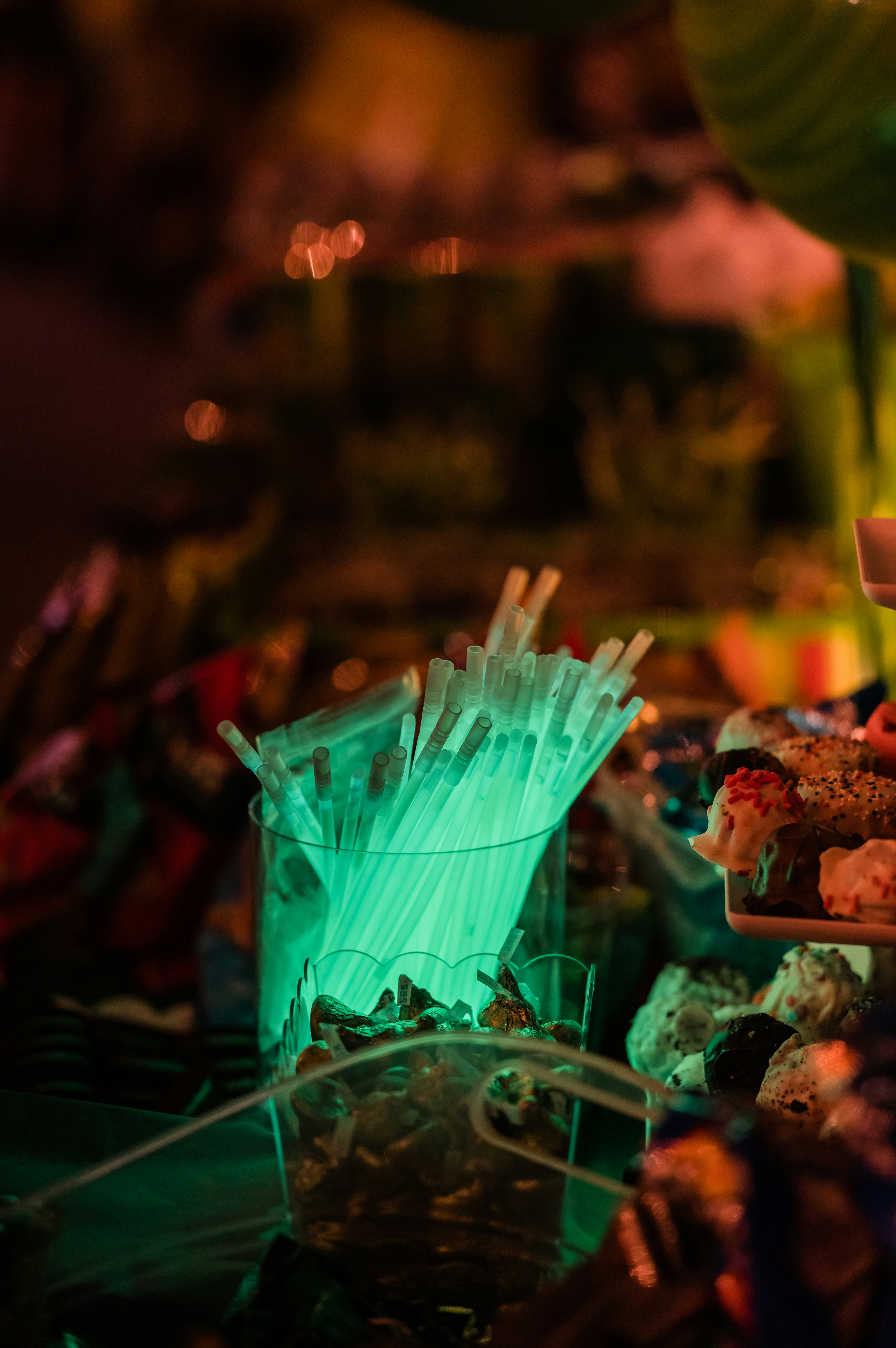 Glowing green straws in a cup.