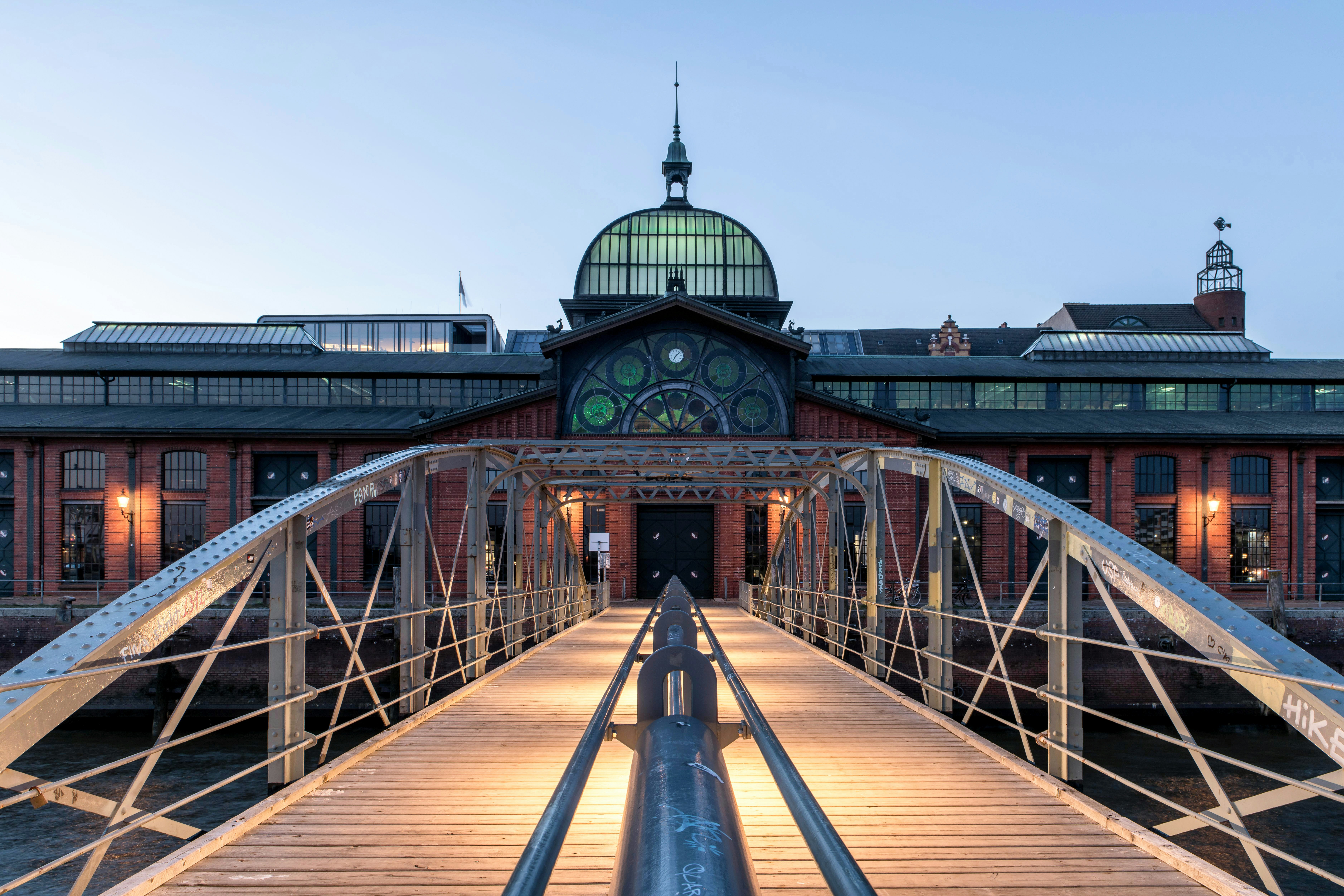 A bridge leads to a beautiful european building.