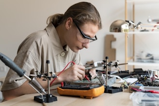 A technician is working on an electronic circuit.
