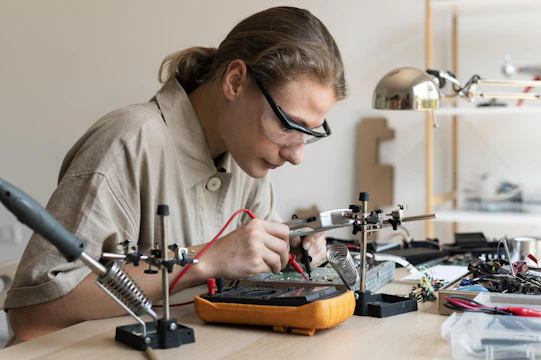 A technician is working on an electronic circuit.