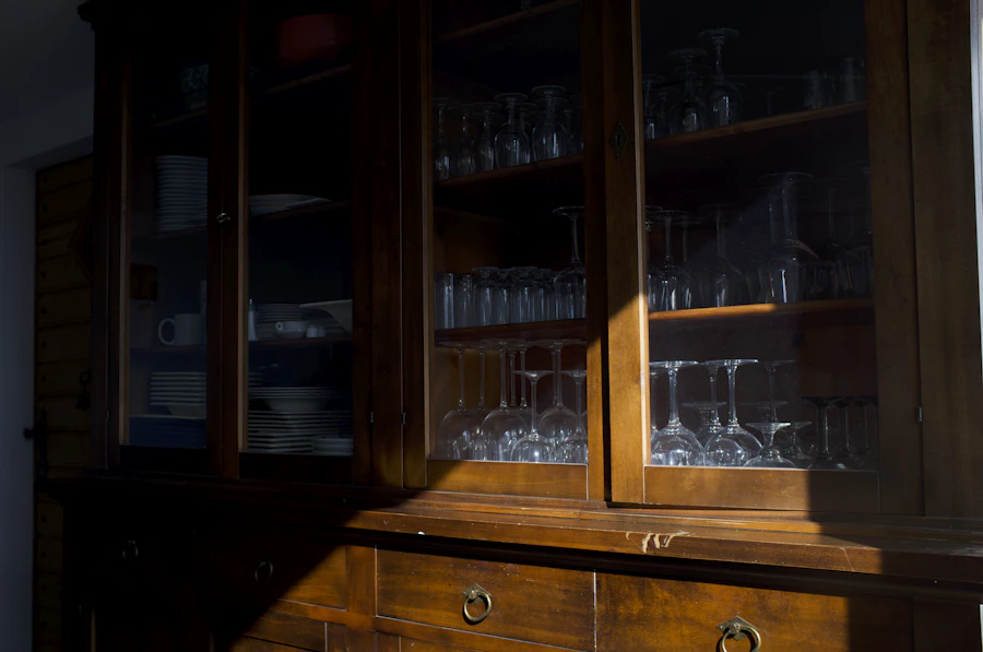 Walnut storage sideboard with glassware inside