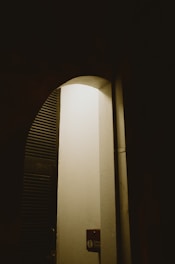 A glowing doorway contrasts with shadows.