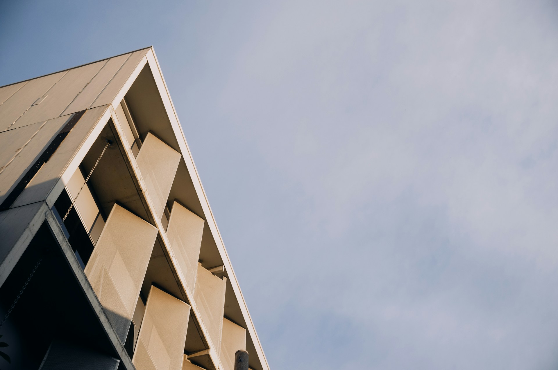 Modern building's corner against the sky.