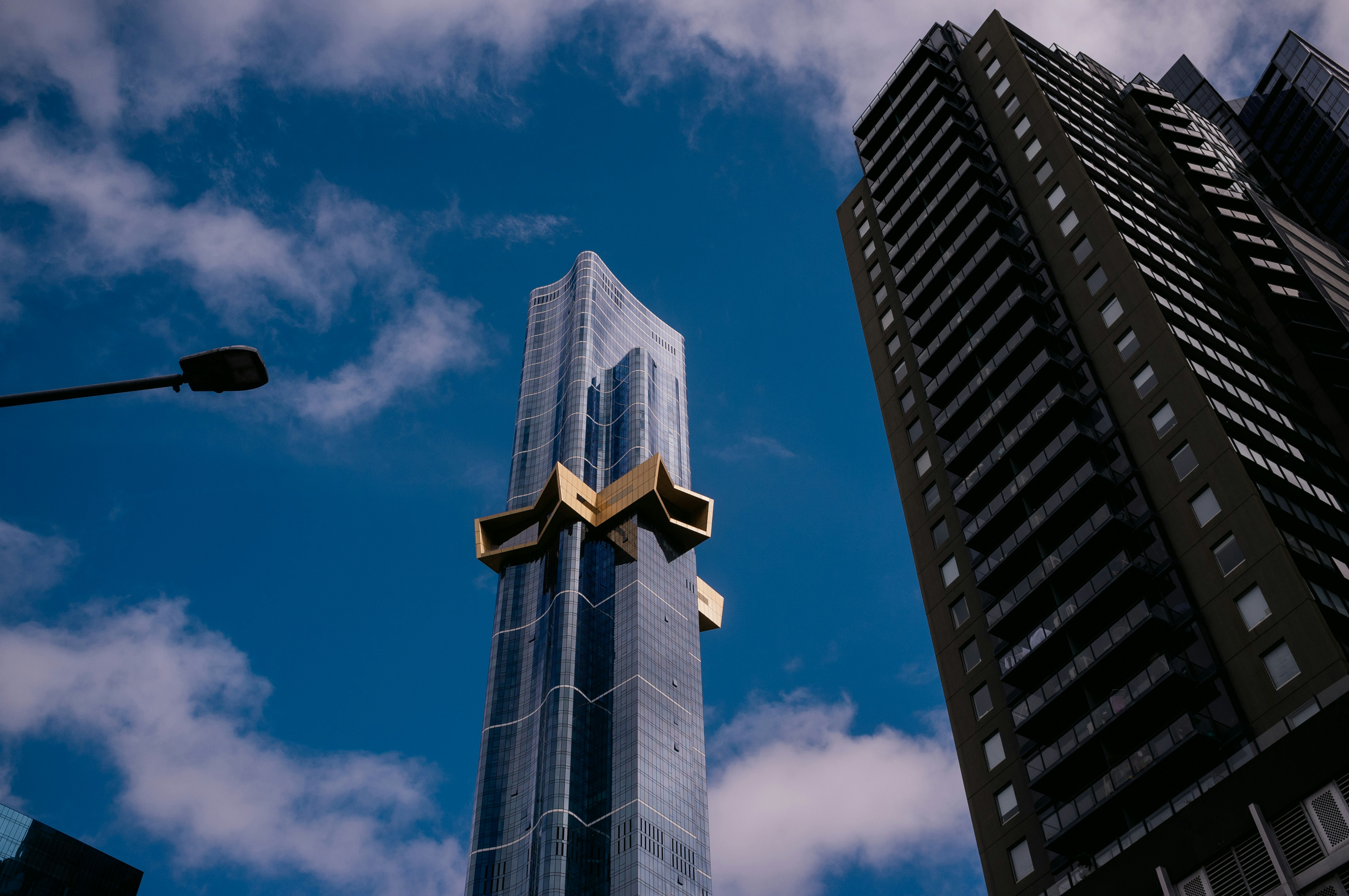 Tall residential tower against blue sky