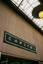 The capitol sign is lit up on a building.
