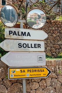 Road signs point to destinations in Palma and Soller.