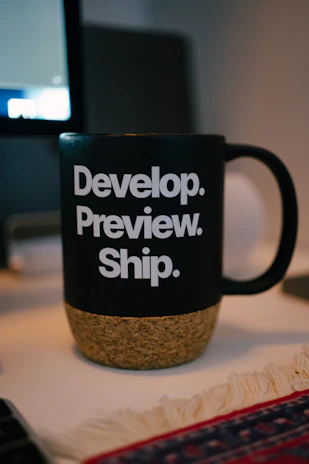 The mug shows the development process steps.