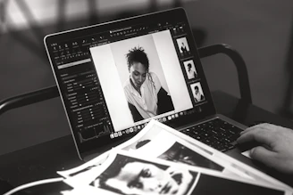 Someone edits a photo on a laptop