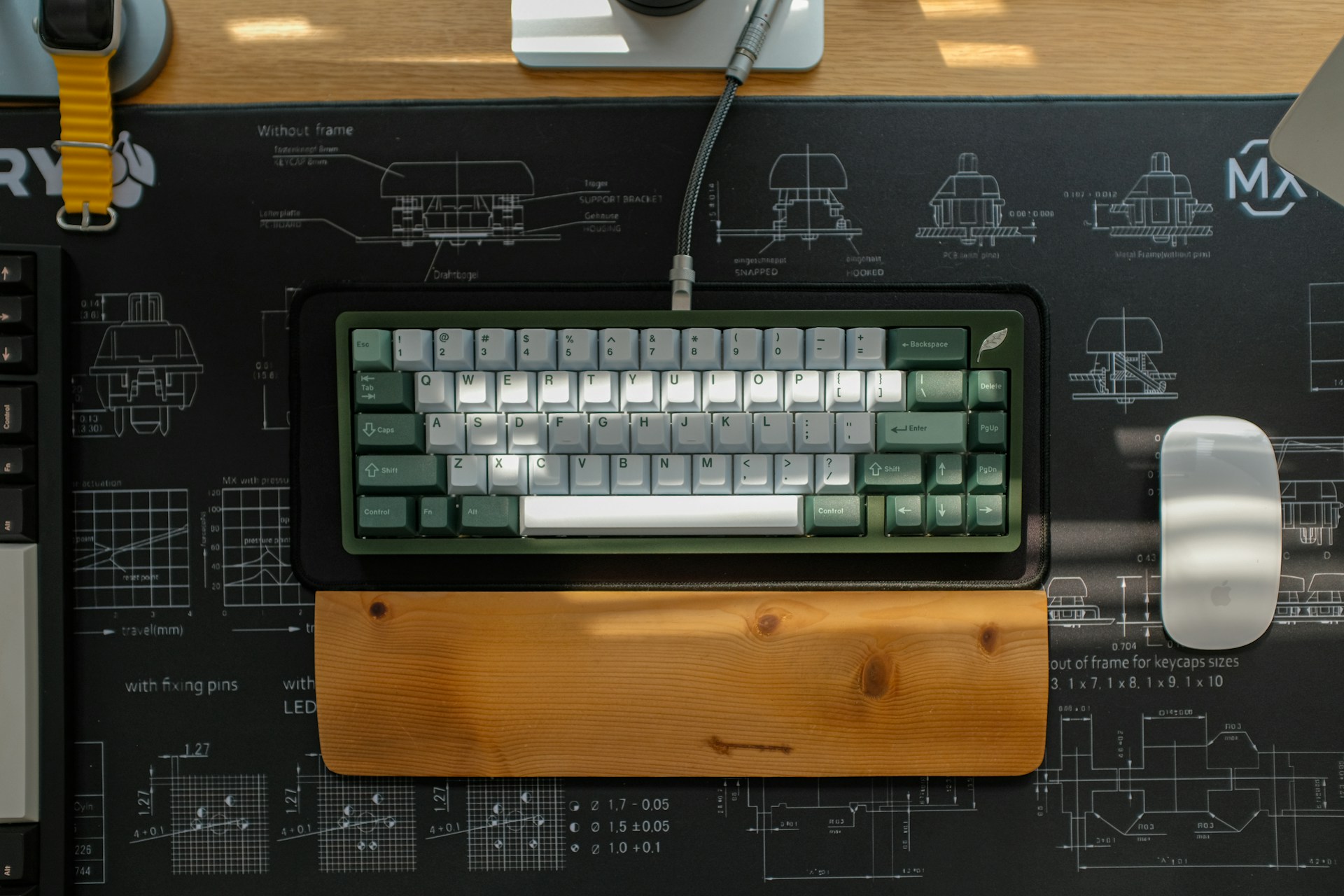 A mechanical keyboard and mouse on a desk.