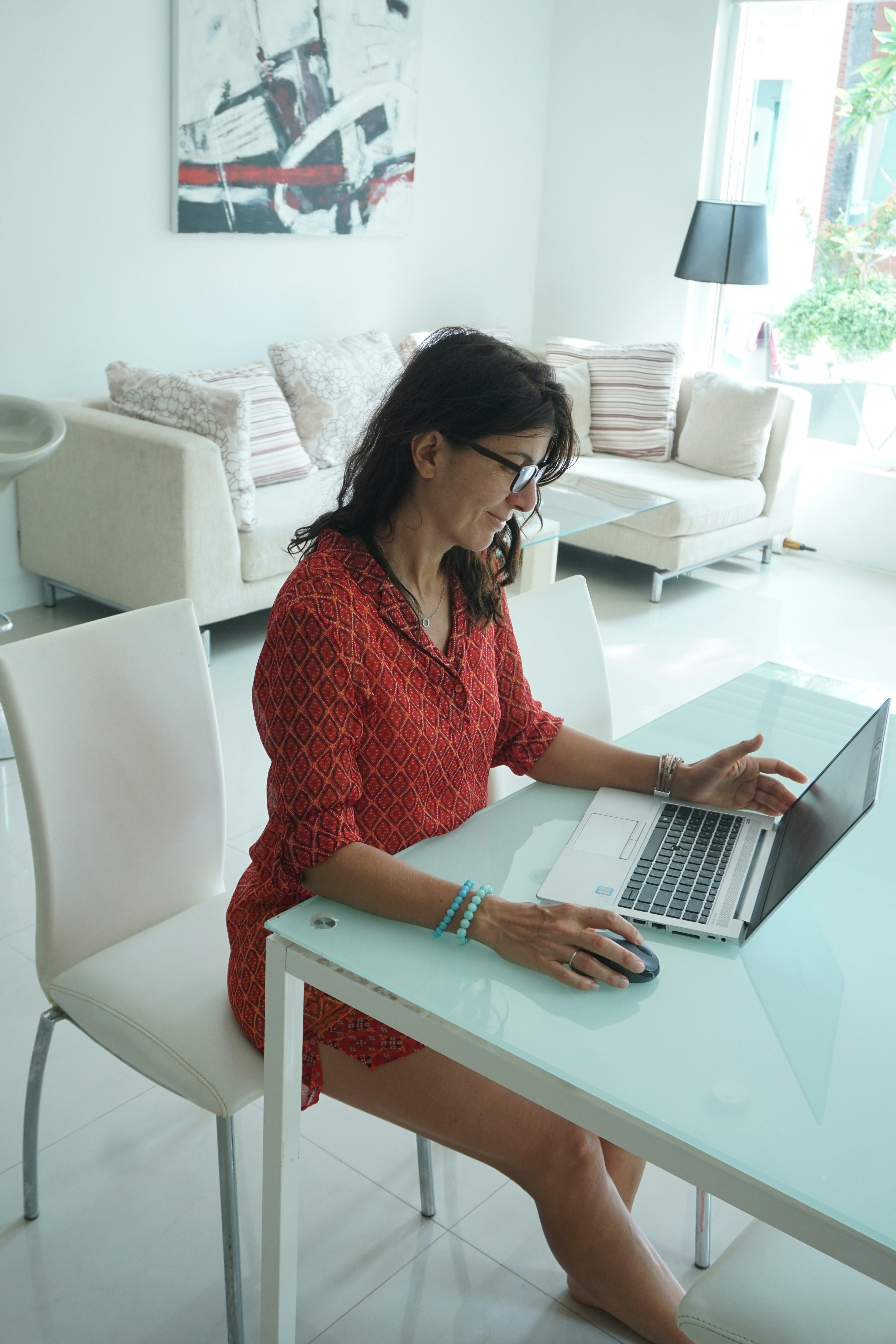 Woman works on her laptop at a table.
