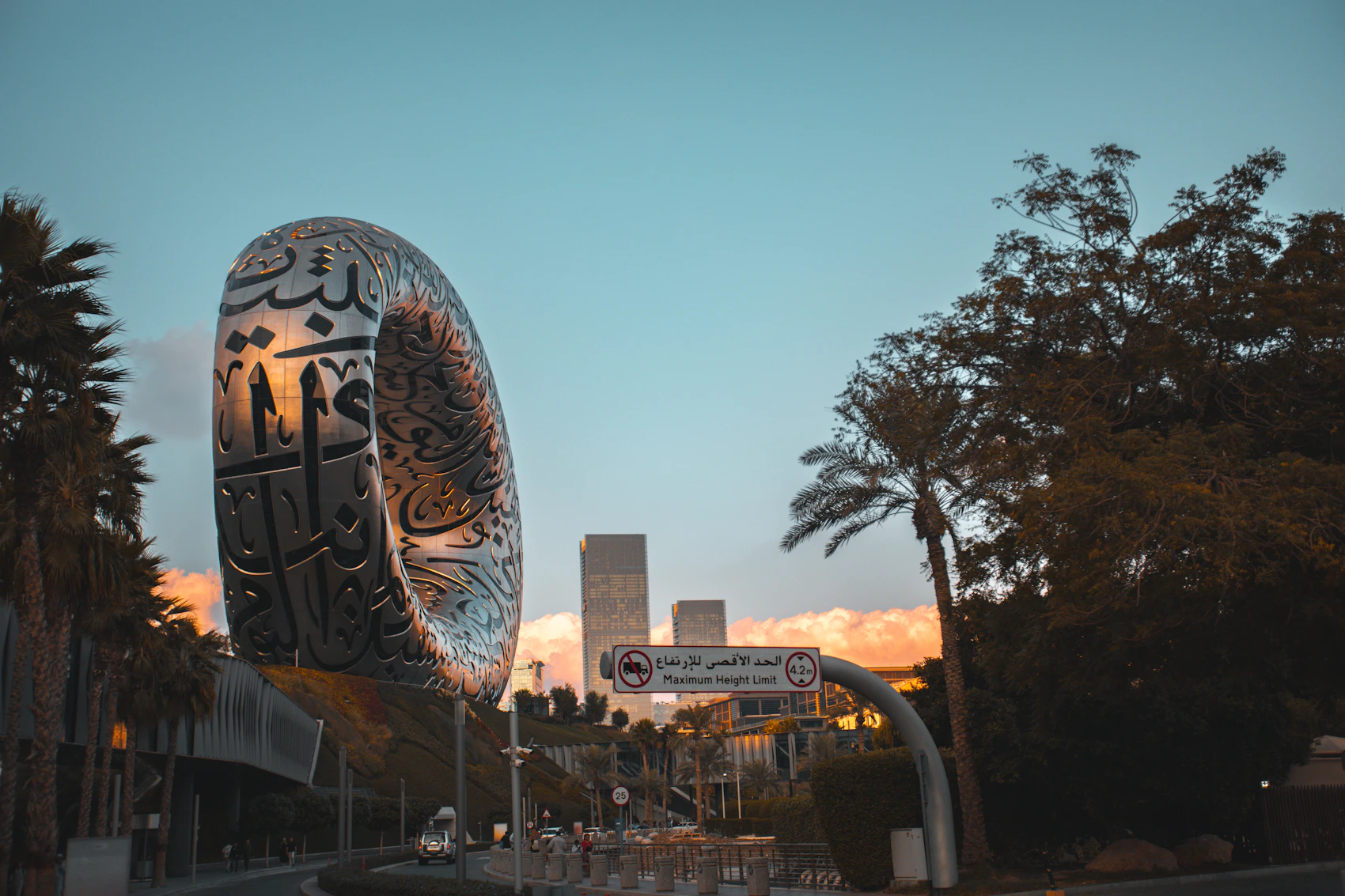 The Museum of the Future in Dubai framed by palms at sunset