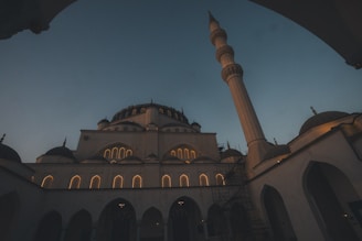 A mosque stands tall against the twilight sky.