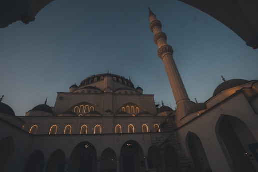A mosque stands tall against the twilight sky.