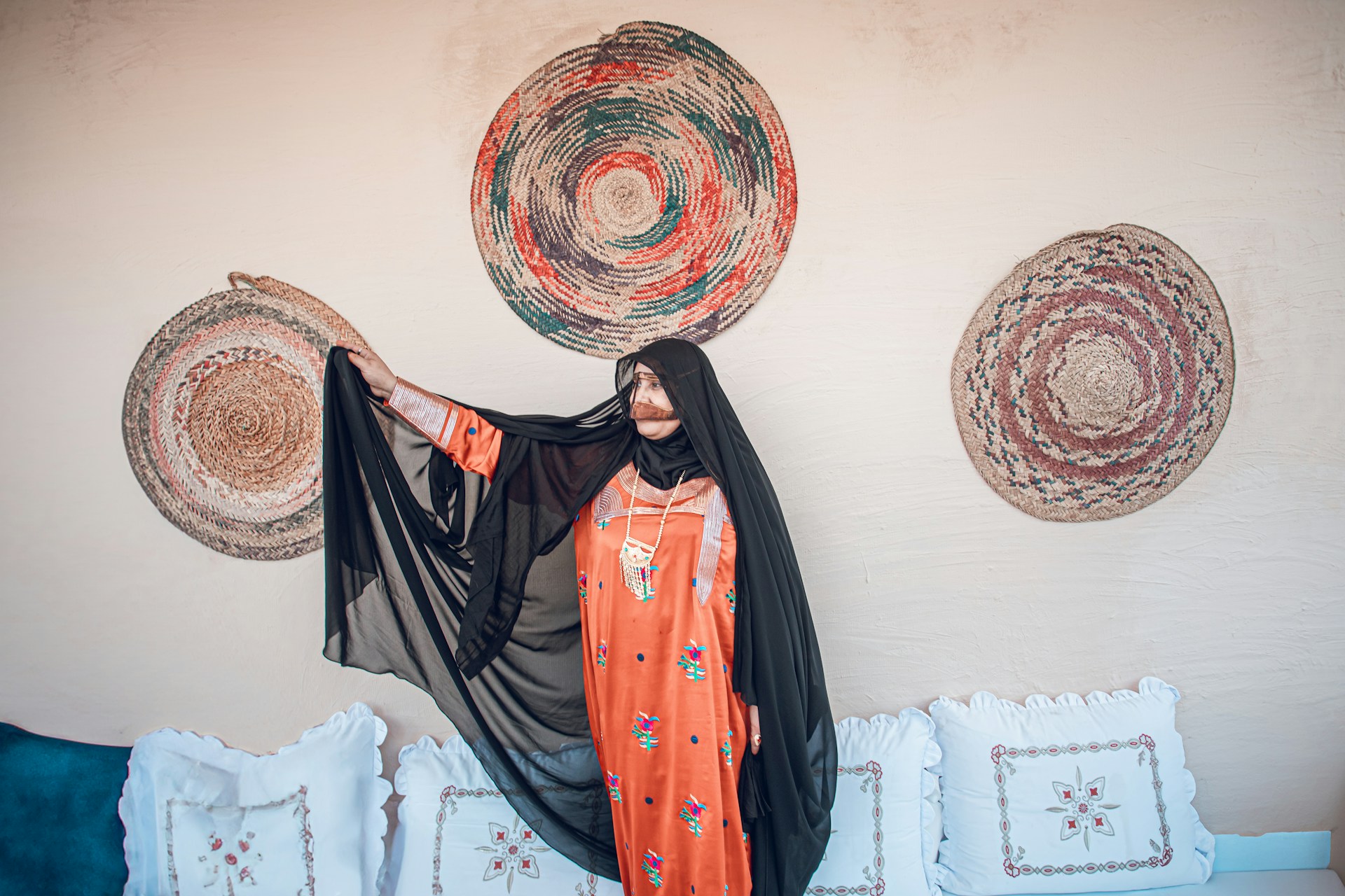 Woman in traditional attire poses elegantly.