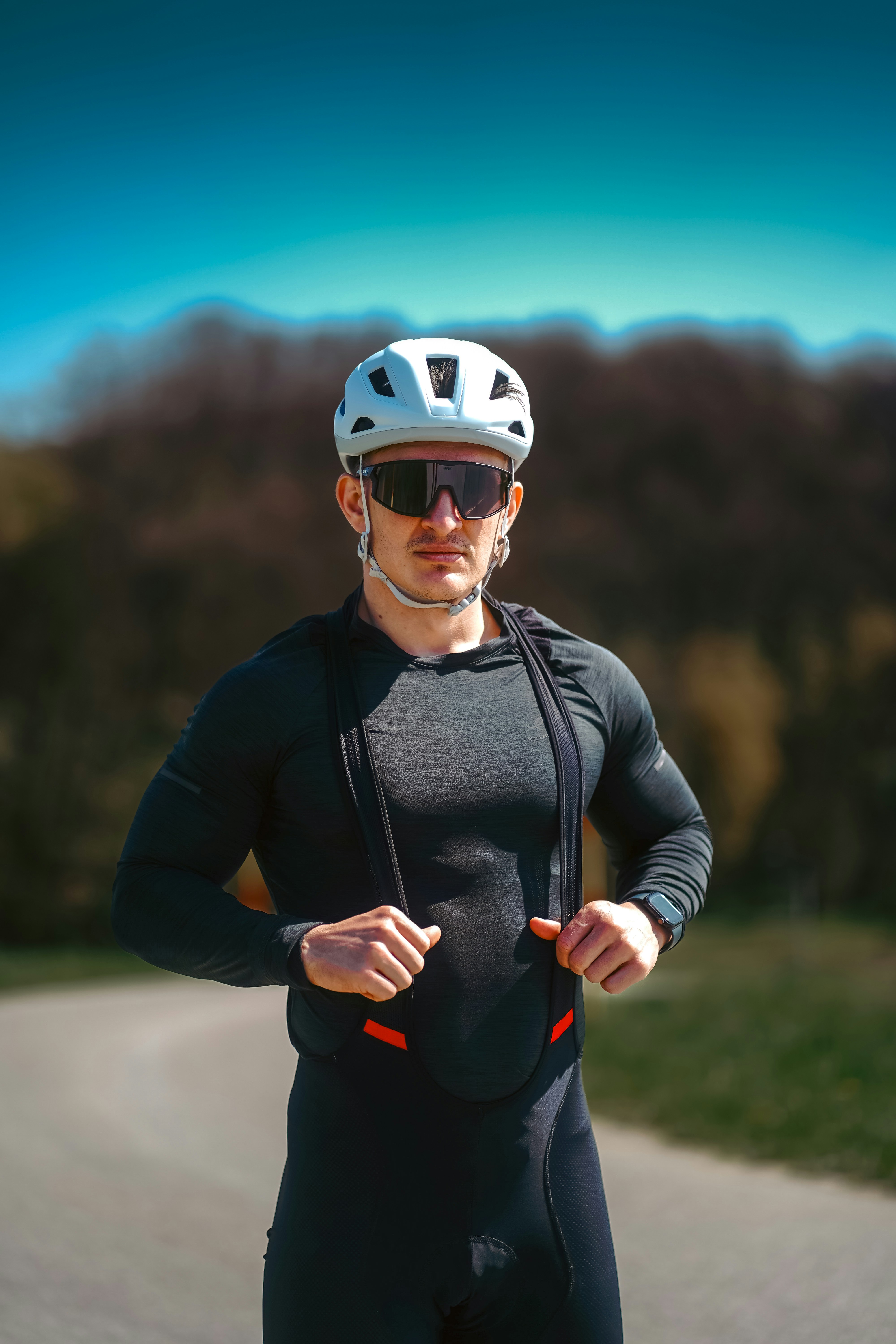 Cyclist in gear poses confidently for a photo.