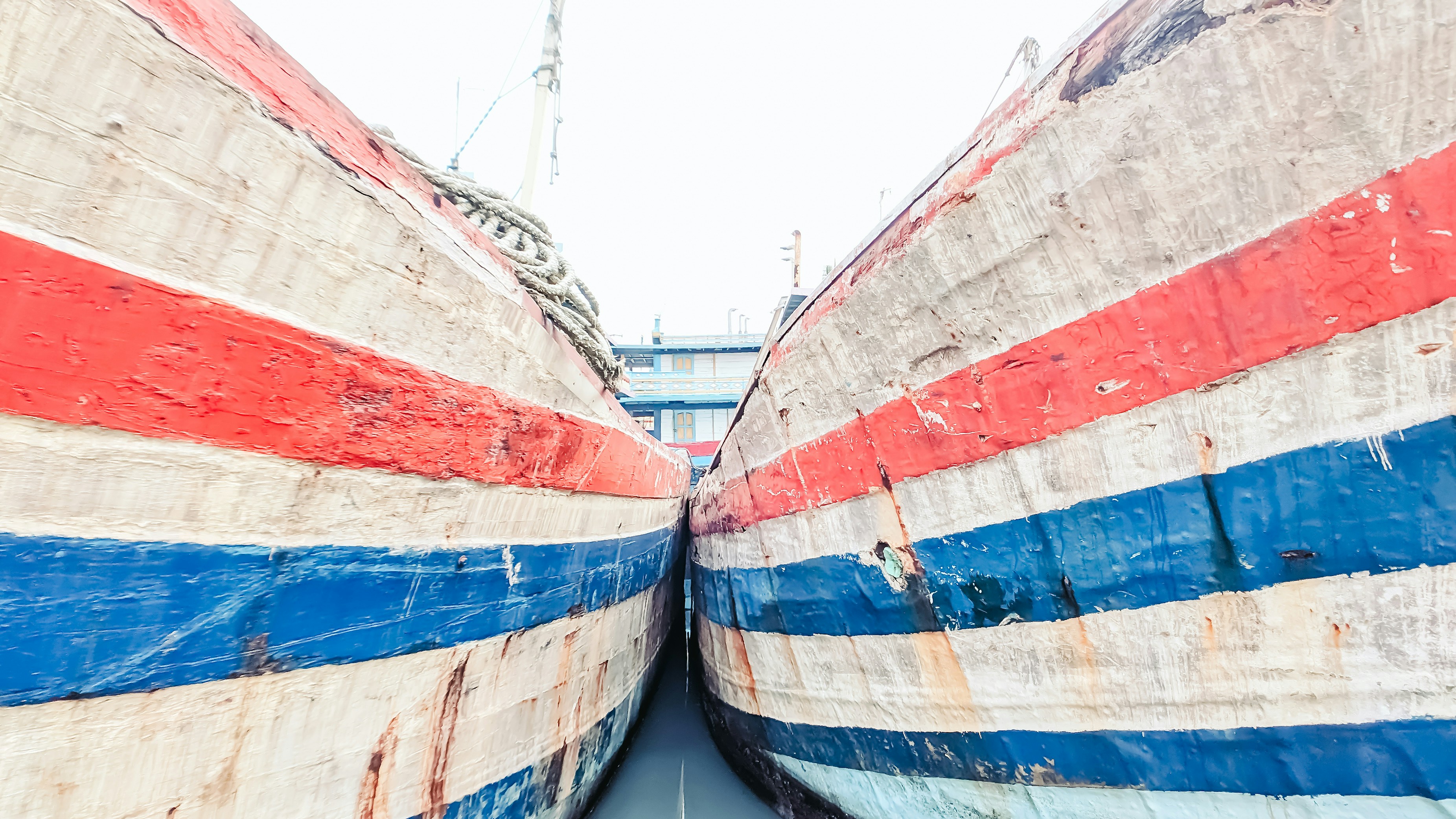 Two colorfully painted boats sit side by side.