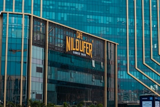 A modern building with a cafe niloufer sign.
