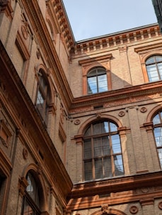 A brick building's exterior in the bright daylight.