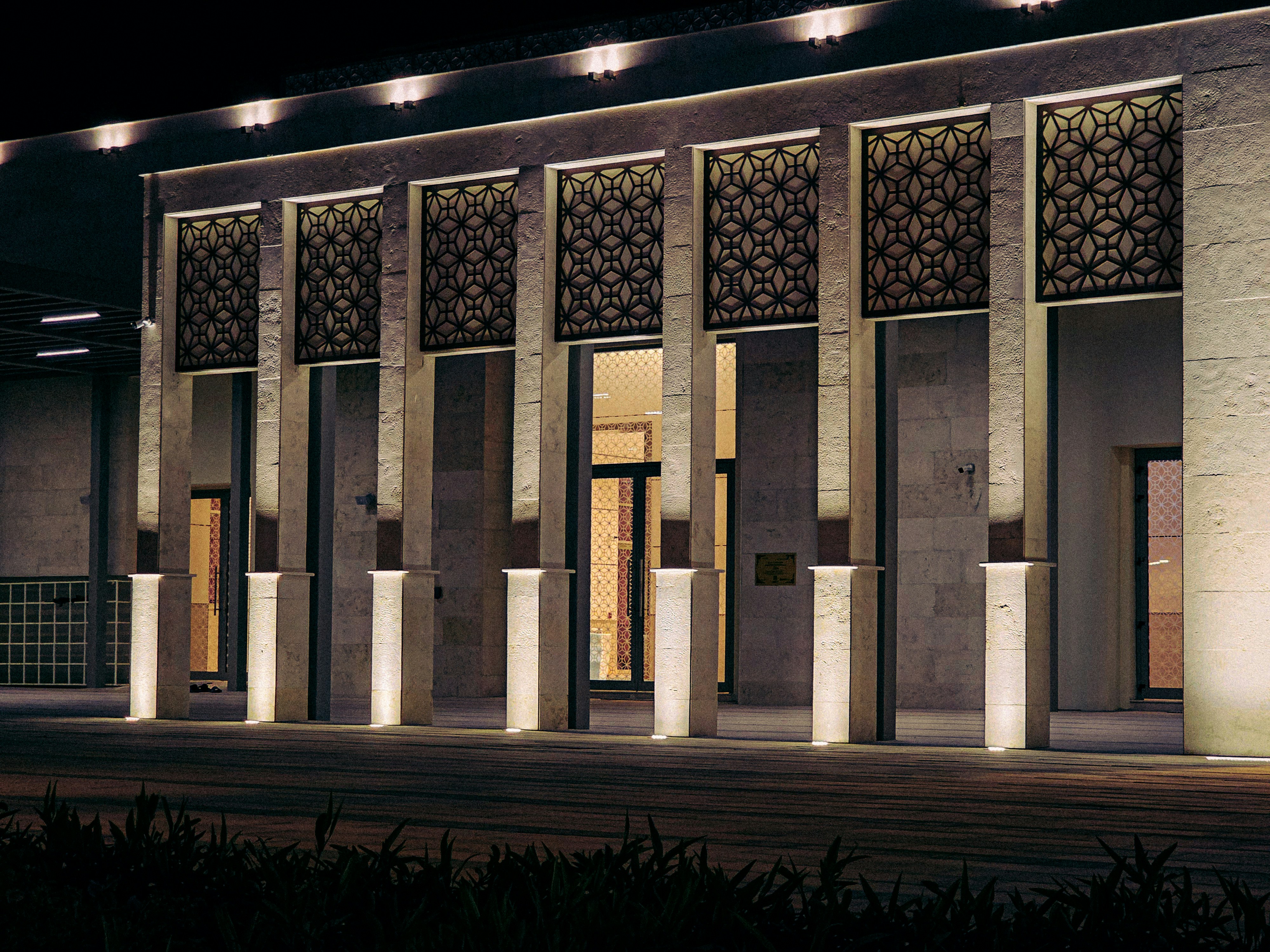 The facade of a well-lit building at night. photo – Free Building Image ...