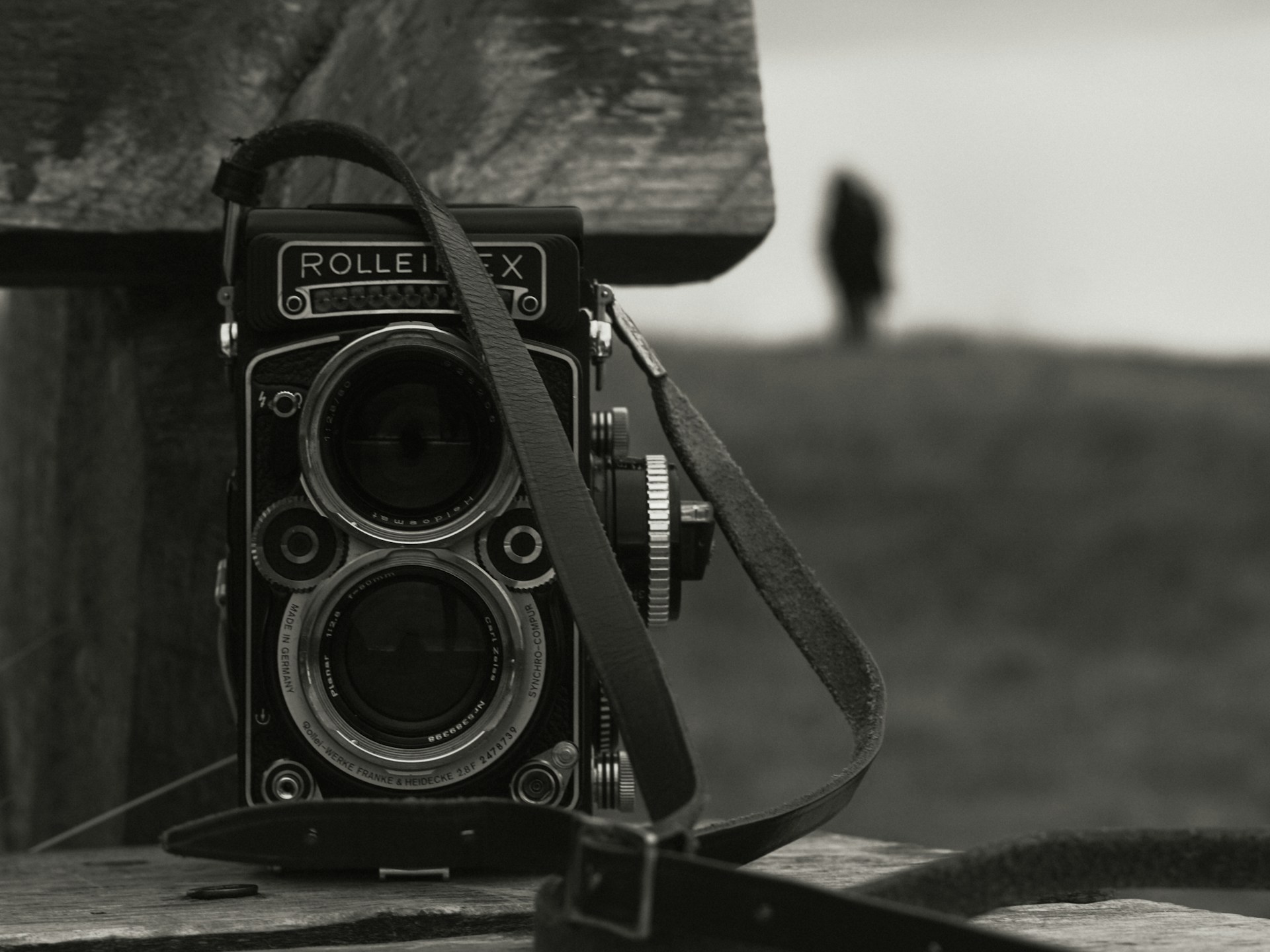 A vintage rolleiflex camera sits outdoors.