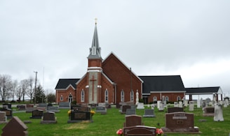 A church sits among a quiet graveyard.