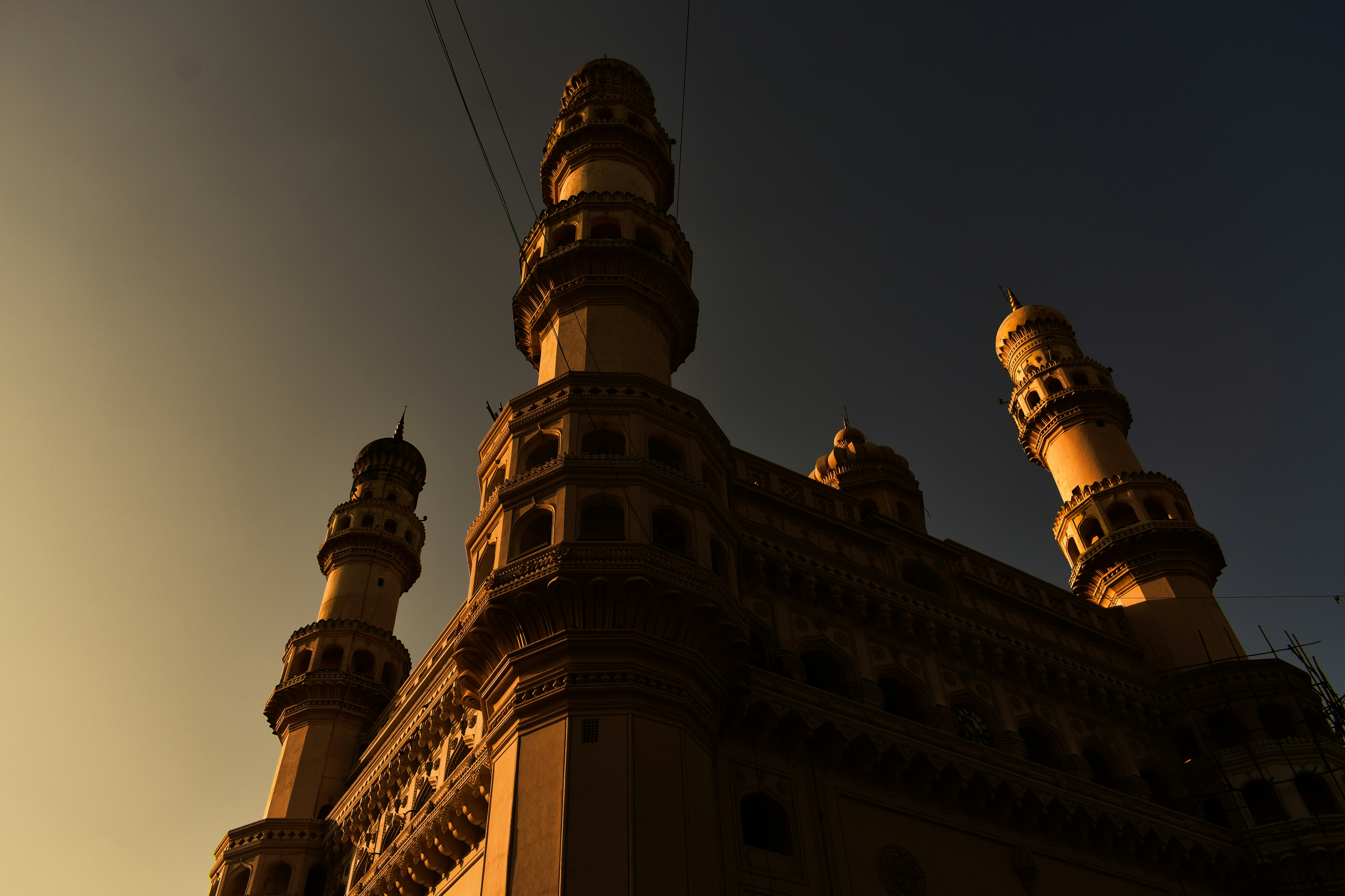 Charminar in silhouette against the sky.