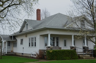 A white house with a front porch.