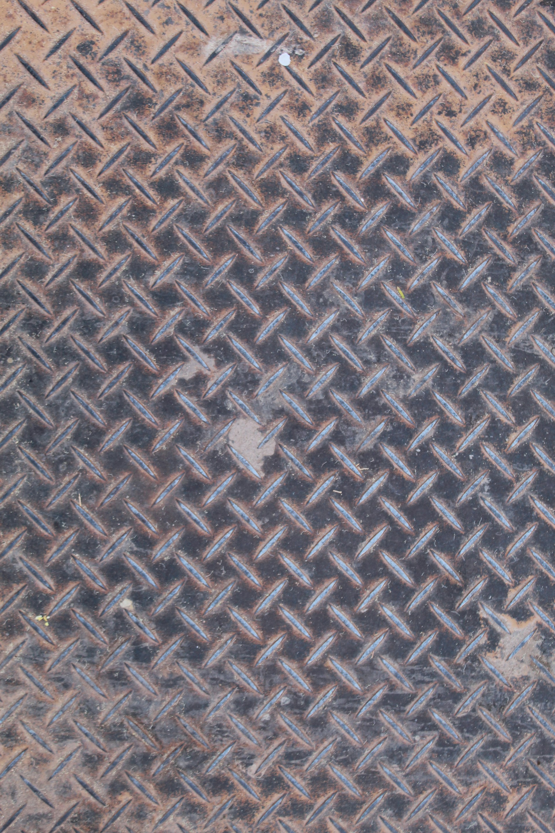 A textured, rusty metal diamond plate.