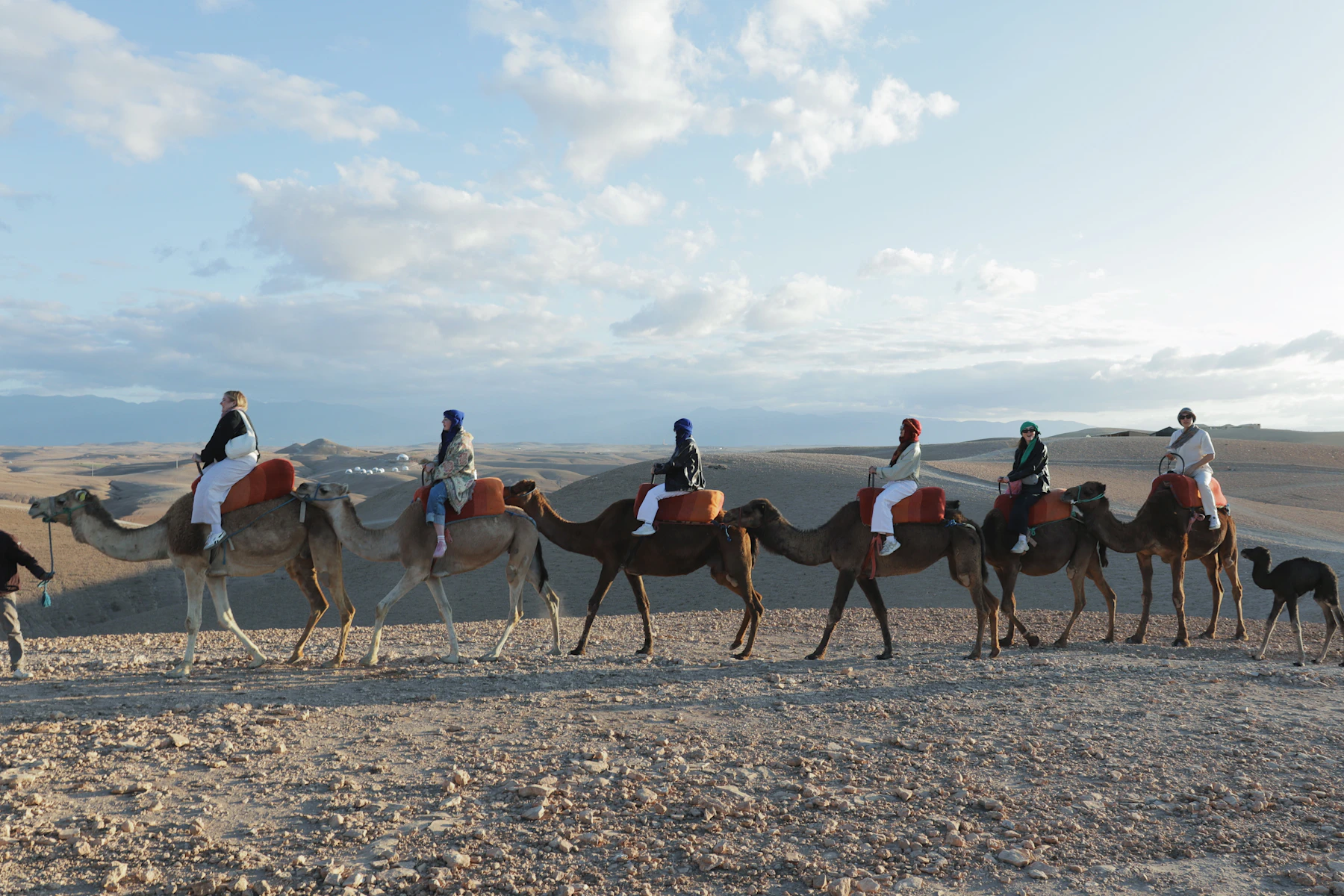 A line of camel riders crossing the Agafay desert