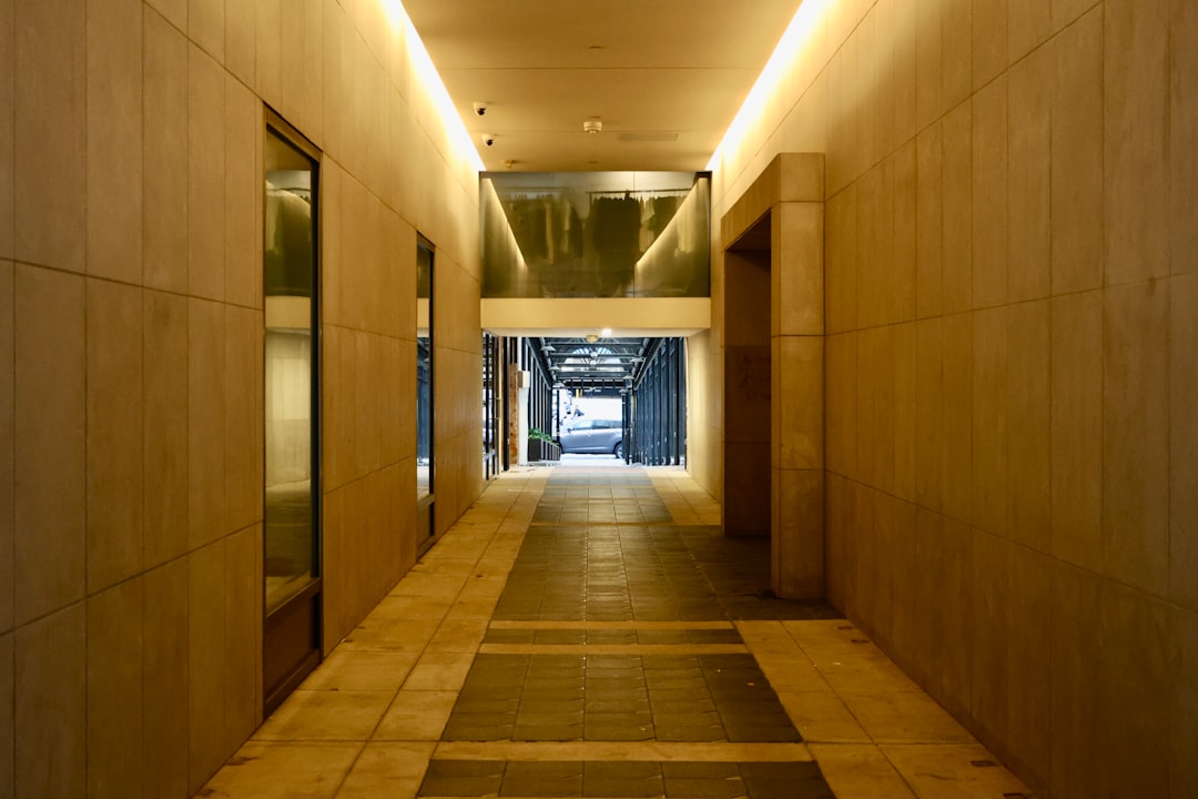 A modern hallway leads to an outside entrance.,