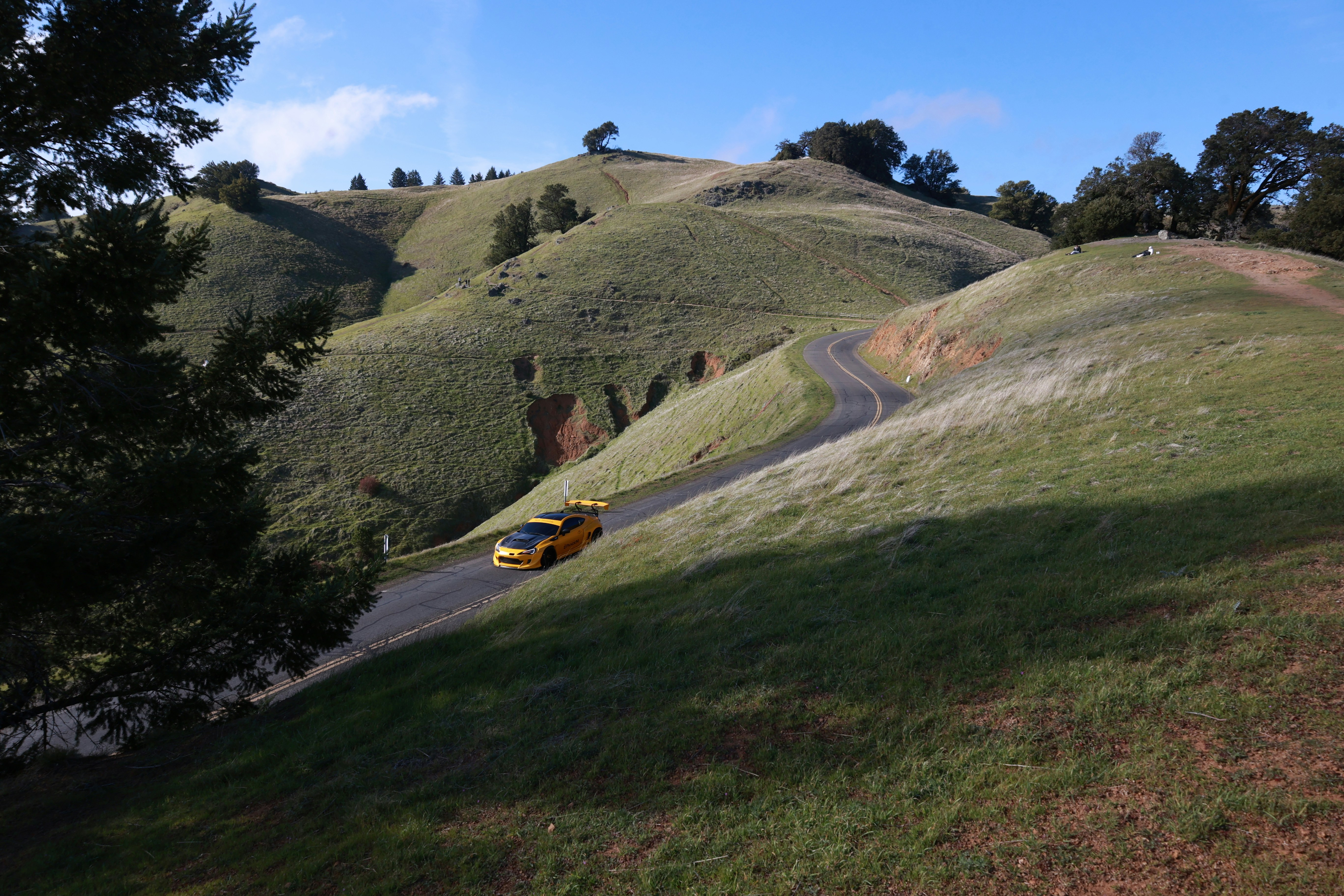 Lamborghini sports car on a scenic hillside drive