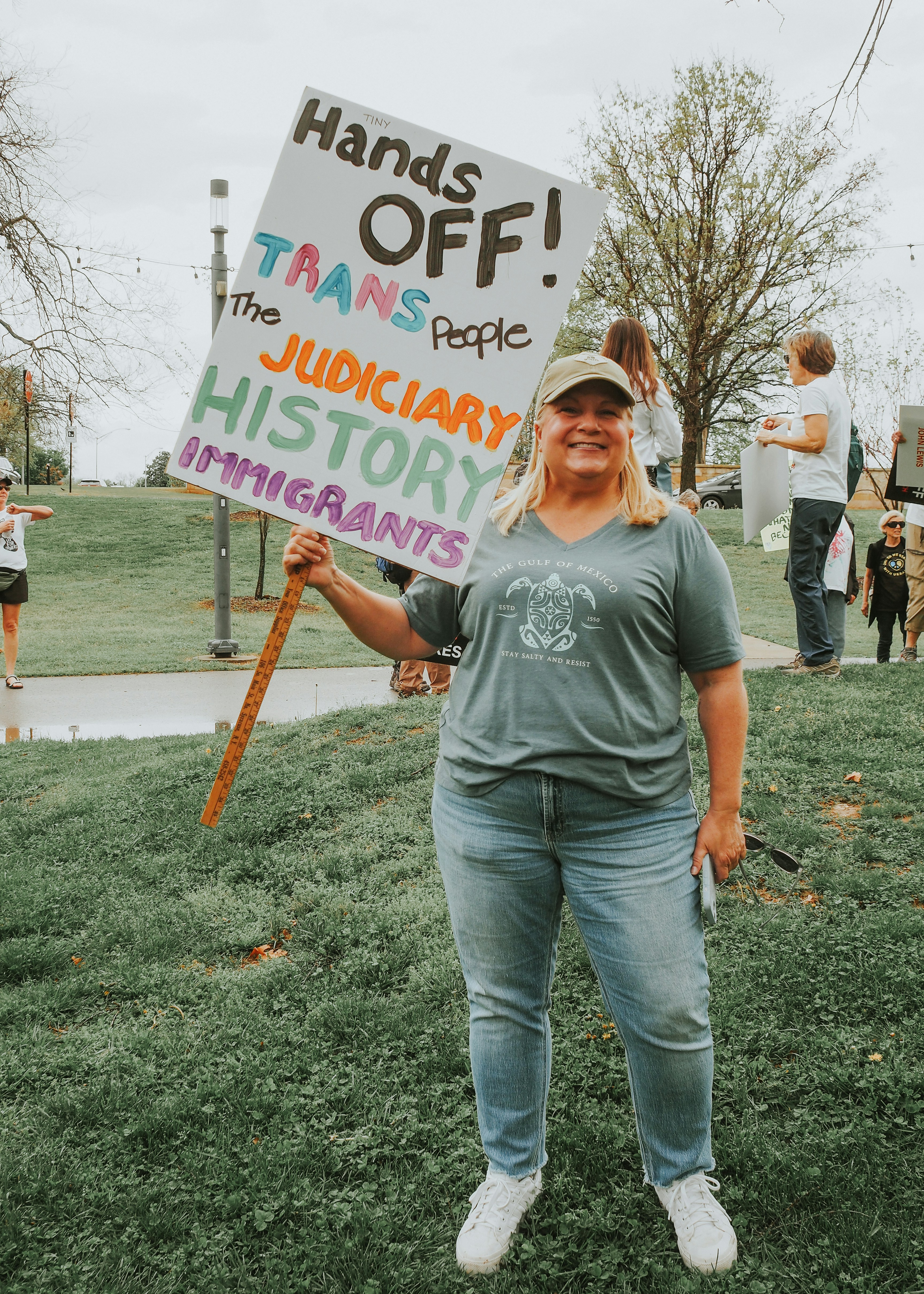 Woman protests with a sign supporting marginalized groups. photo – Free ...