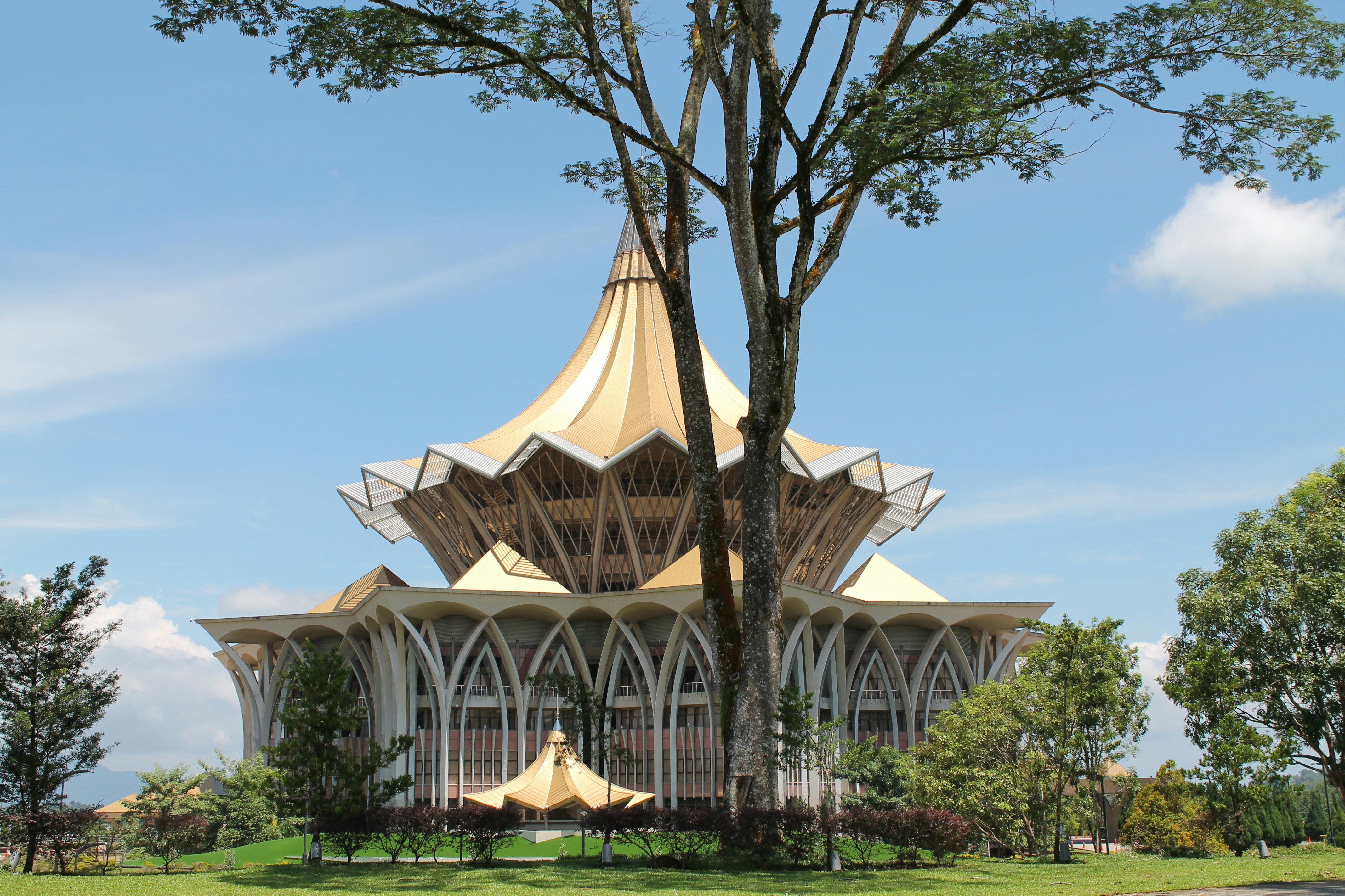 A striking gold-roofed building stands under a blue sky.
