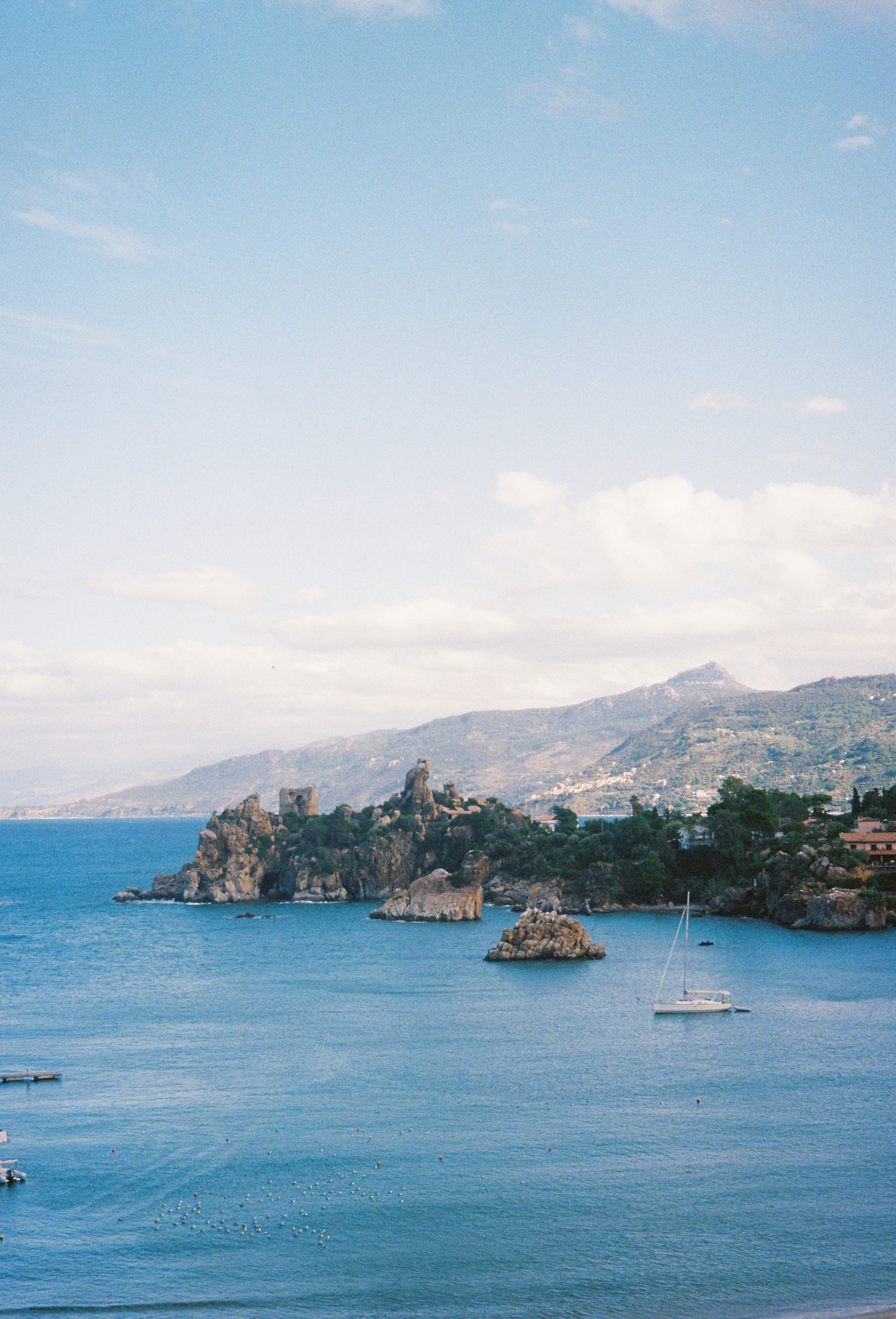 Beautiful coastal view with rocky islands and boats.