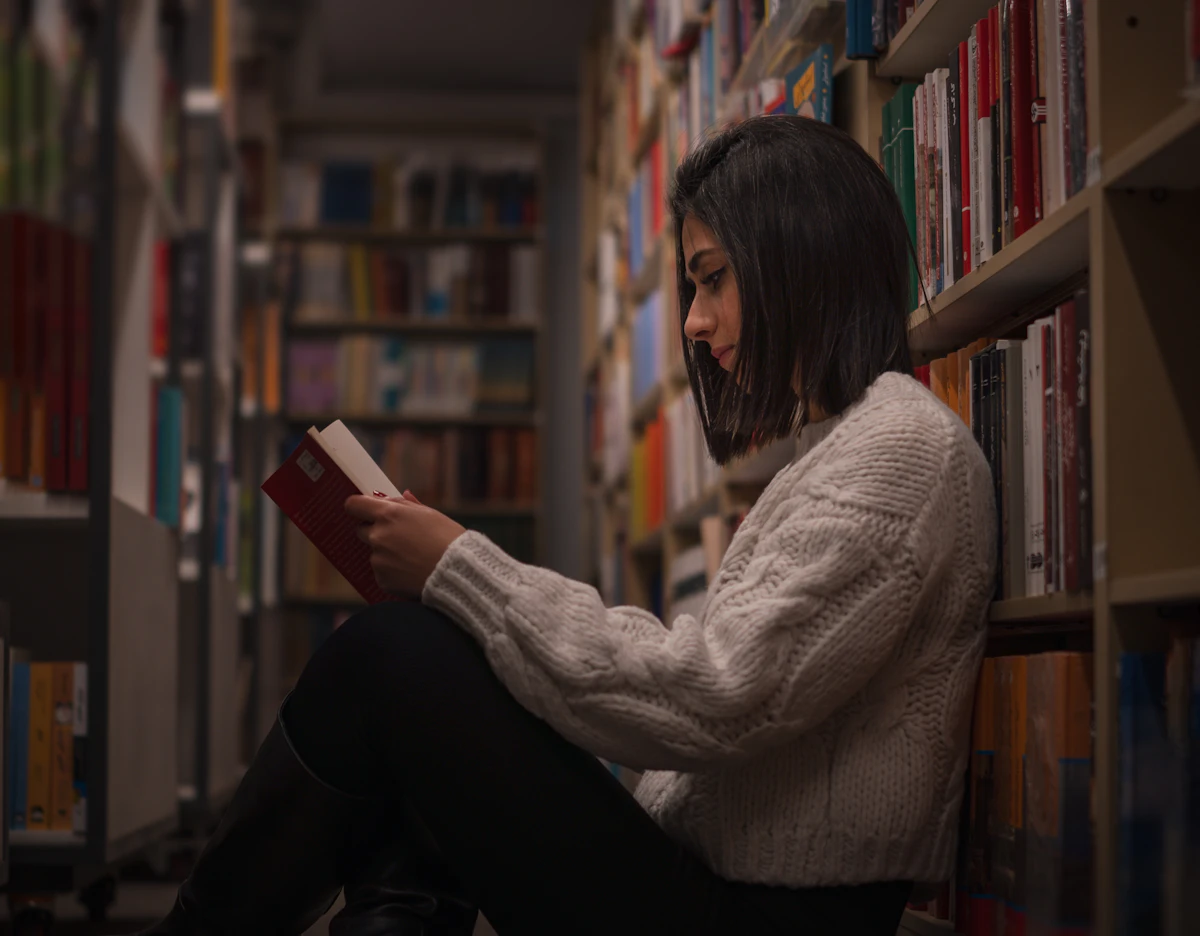 Student reading thoughtfully in a library