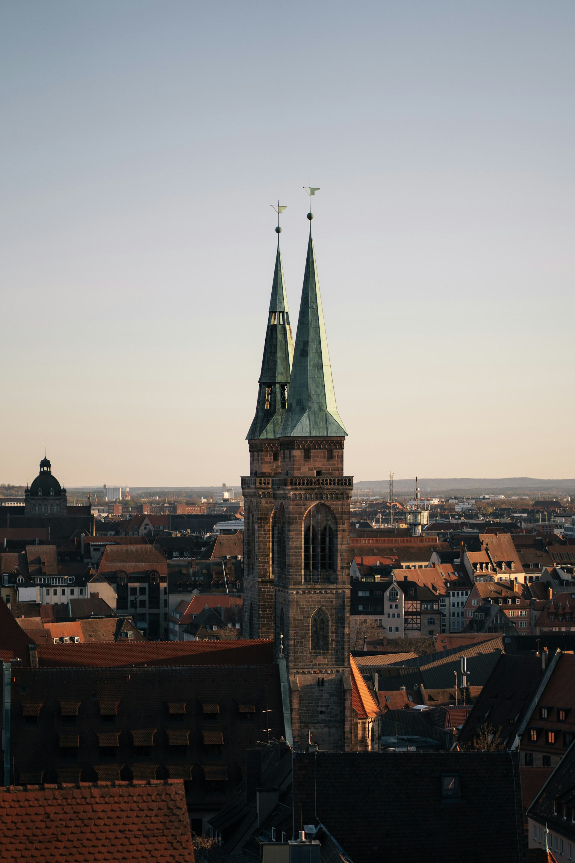 Church towers stand tall over a city skyline.