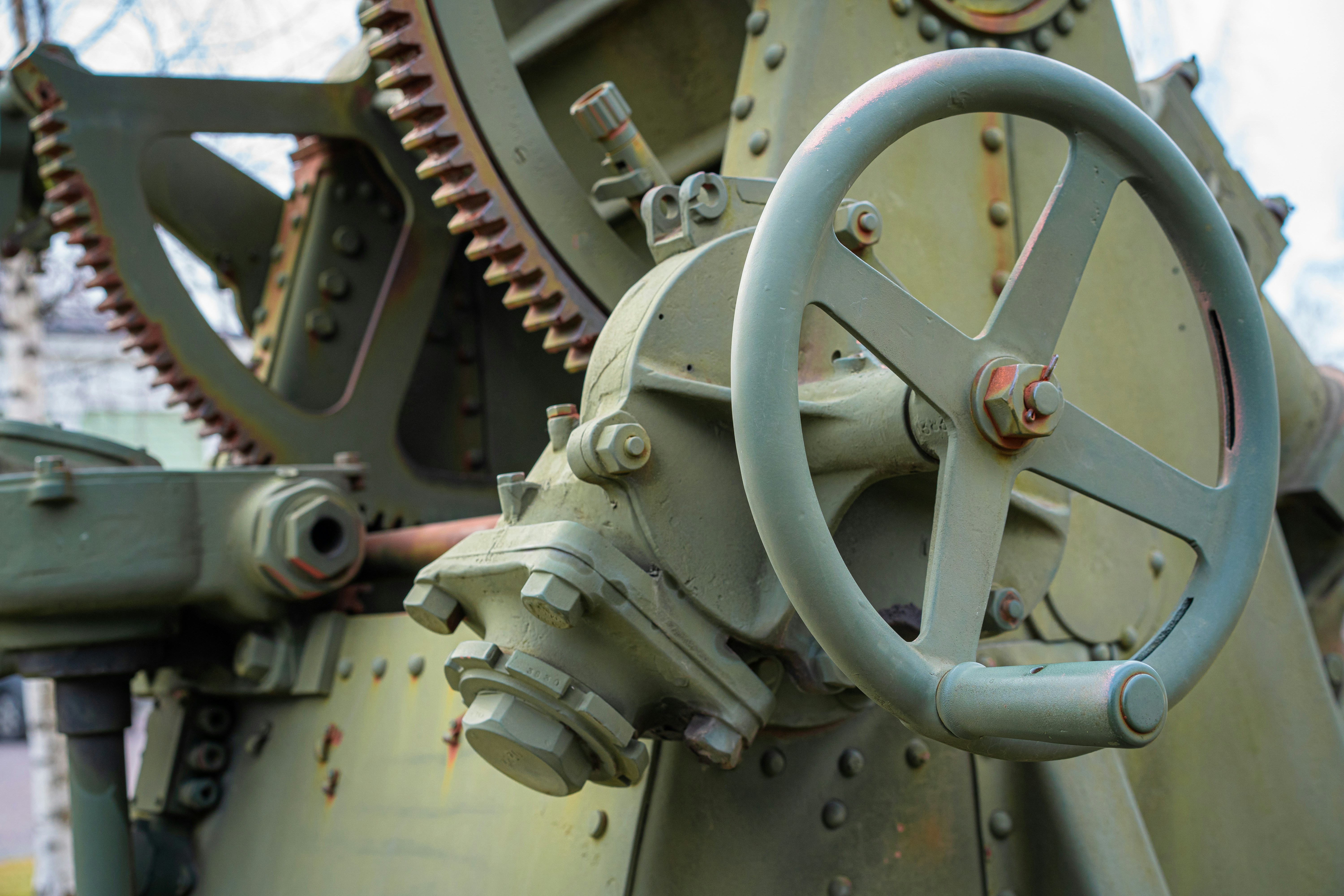 Close-up of gears and a steering wheel.